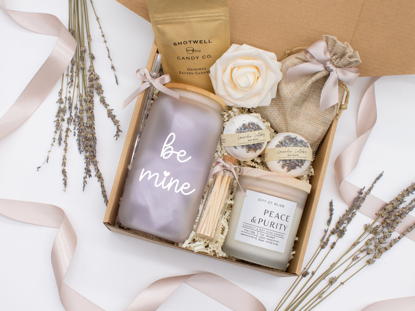 Spa gift basket for her with fragrant bath treats, glass cup, soft caramels, relaxing candle, and a beautifull rose. Pick from one of the three scents: Rose, Lavender, or Jasmine. Perfect to pamper and honor her.