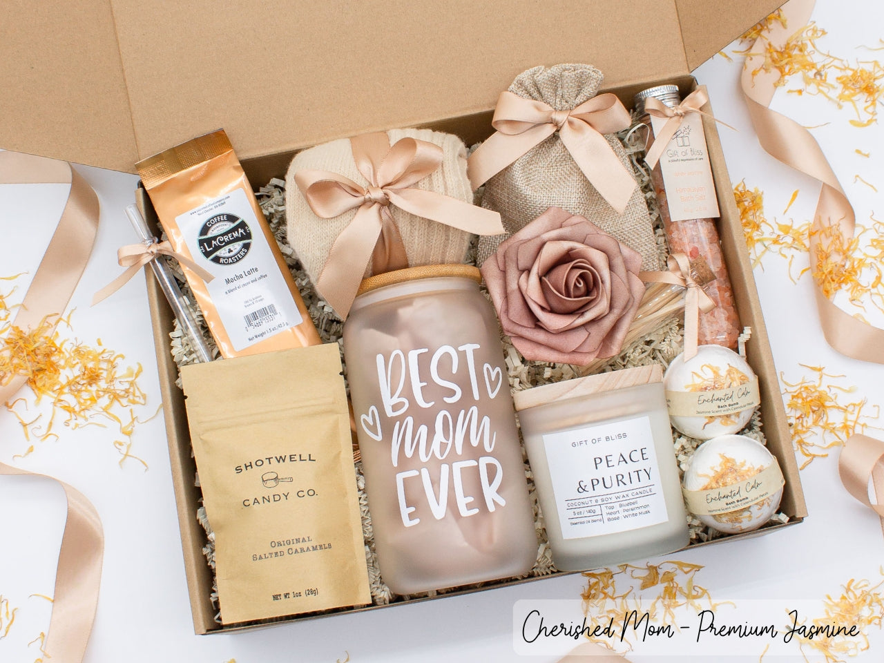 Mom gift box with fragrant bath treats, mom designed glass cup, mocha latte coffe, soft caramels, relaxing candle, cozy socks, and a beautifull rose. Pick from one of the three scents: Rose, Lavender, or Jasmine. Perfect to pamper and honor moms.