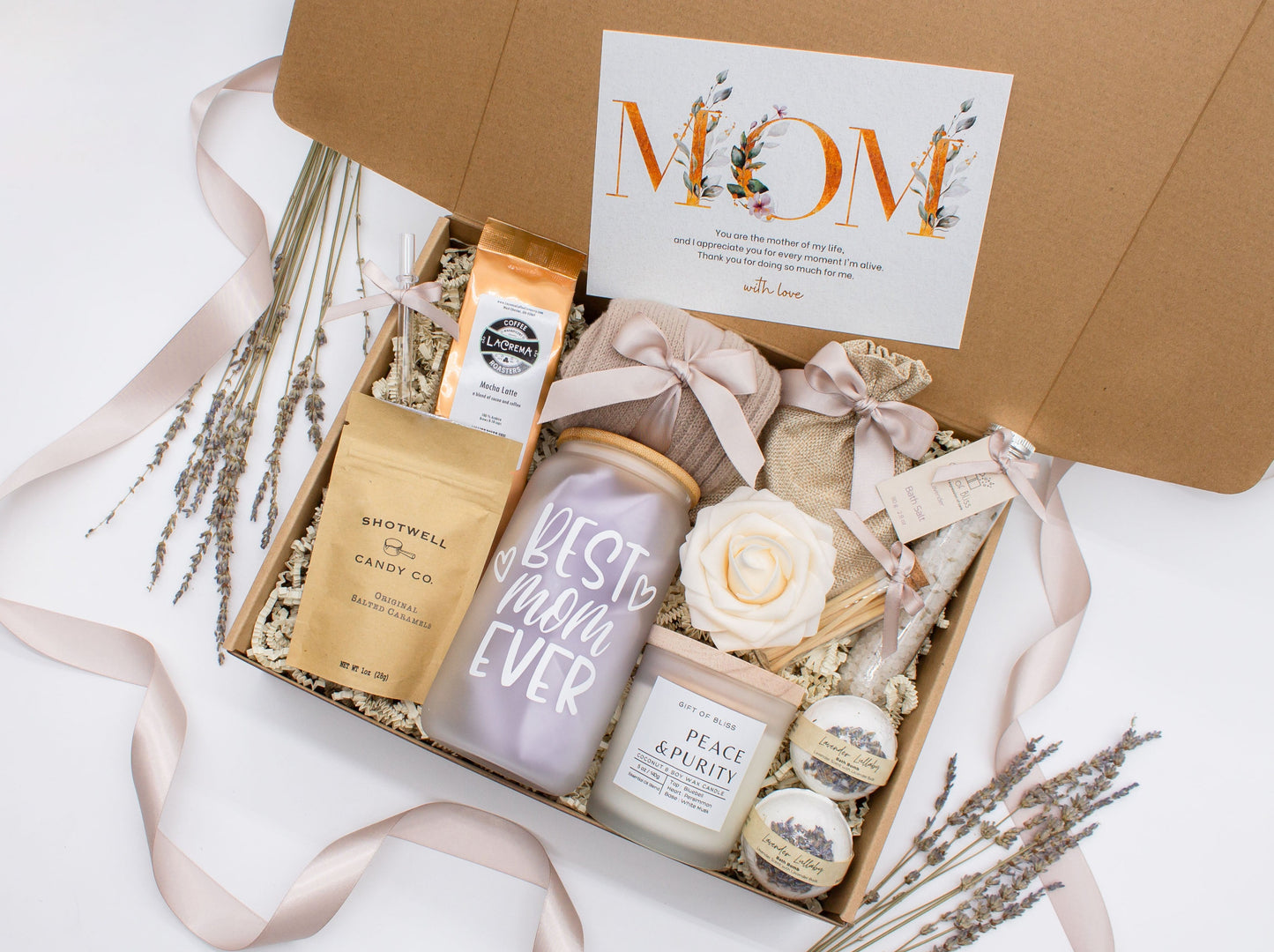 Mom gift box with fragrant bath treats, Best Mom Ever glass cup, mocha latte coffe, soft caramels, relaxing candle, cozy socks, and a beautifull rose. Pick from one of the three scents: Rose, Lavender, or Jasmine. Perfect to pamper and honor moms.