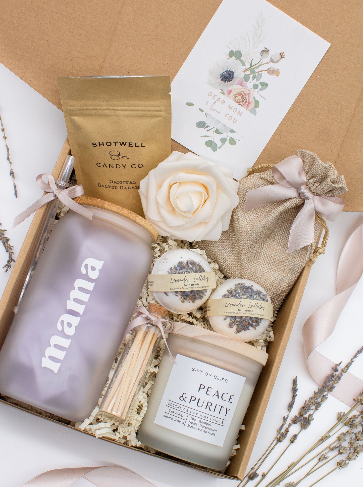 Cherished Mom gift box with fragrant bath treats, a Mama glass cup, soft caramels, a relaxing candle, and a beautifull rose. Pick from one of these three scents: Rose, Lavender, or Jasmine. Perfect to pamper and honor moms.