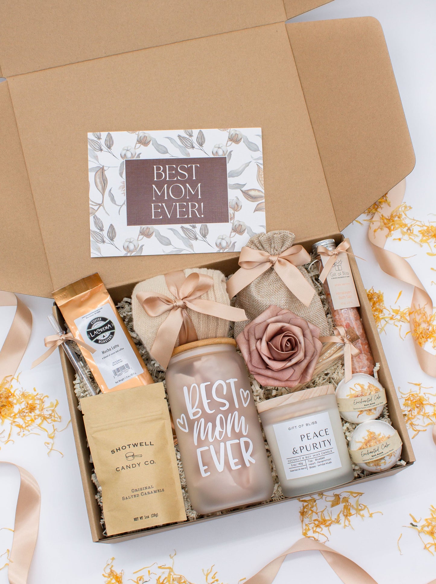 Mom gift box with fragrant bath treats, Best Mom Ever glass cup, mocha latte coffe, soft caramels, relaxing candle, cozy socks, and a beautifull rose. Pick from one of the three scents: Rose, Lavender, or Jasmine. Perfect to pamper and honor moms.