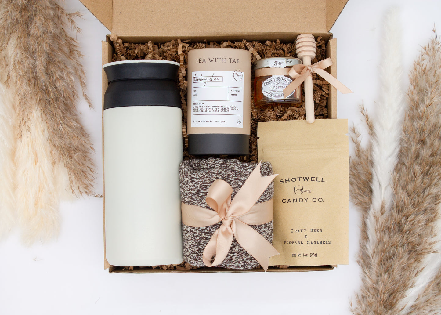 Specially crafted gift box for men, ideal for anyone. Includes a stainless steel tumbler, tea, honey, sweet treats, and cozy socks. Perfect for relaxation & appreciation, complete with a personalized greeting card.