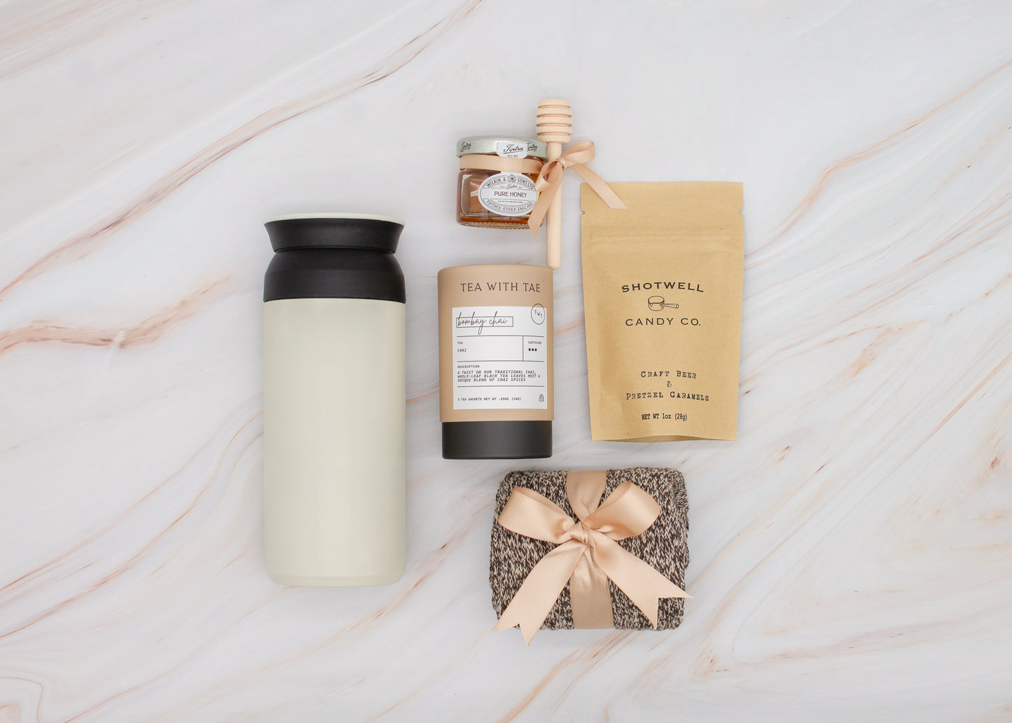 Specially crafted gift box for men, ideal for anyone. Includes a stainless steel tumbler, tea, honey, sweet treats, and cozy socks. Perfect for relaxation & appreciation, complete with a personalized greeting card.
