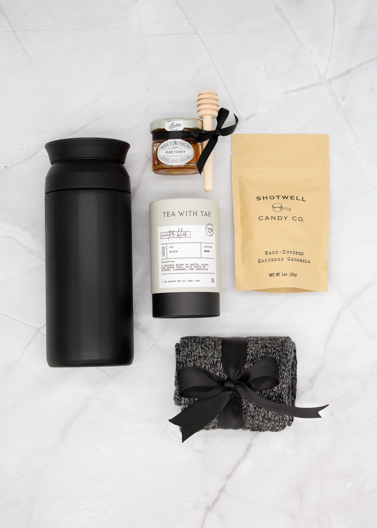 Specially crafted gift box for men, ideal for anyone. Includes a stainless steel tumbler, tea, honey, sweet treats, and cozy socks. Perfect for relaxation & appreciation, complete with a personalized greeting card.