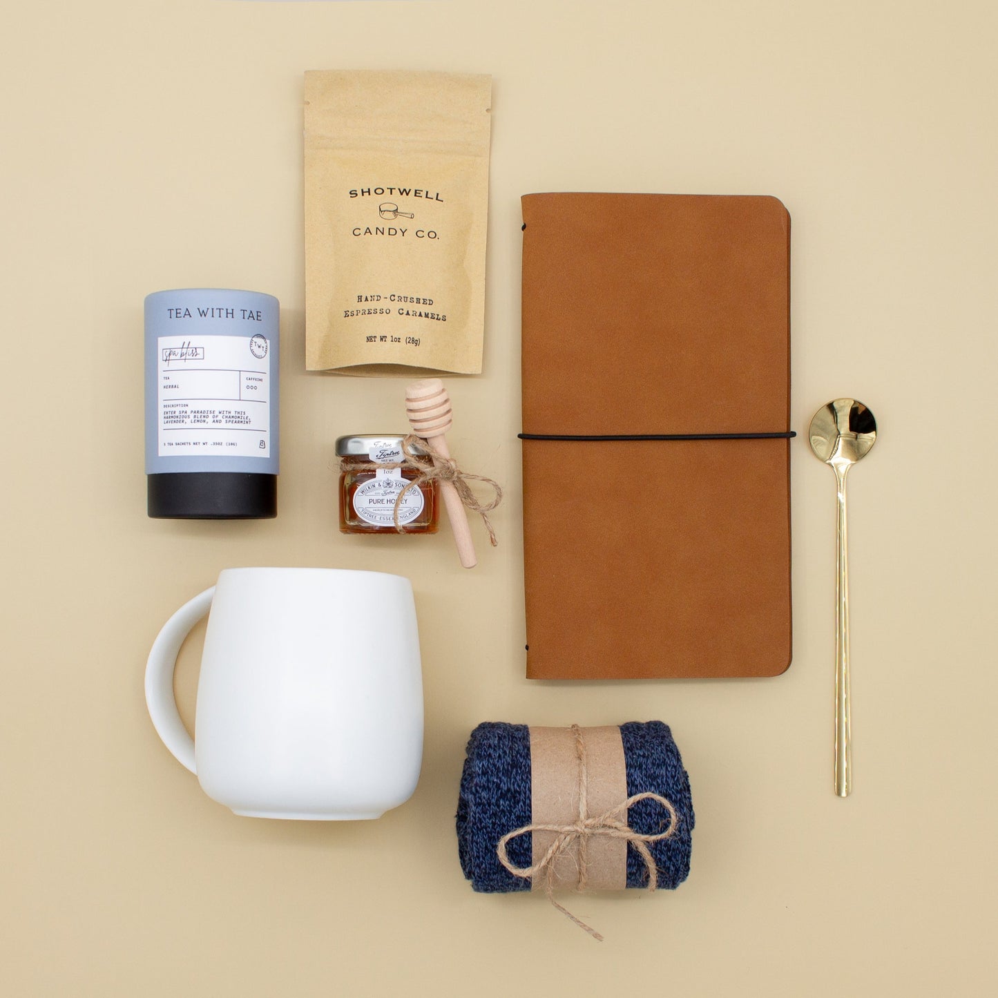 The Dapper Haven (Specially crafted gift box for men. Includes a ceramic mug, golden spoon, tea, honey with dipper, caramel candy, men's socks, and a vegan leather notebook. A gift that brings joy and a touch of tranquility to anyone who loves life's finer things.)
