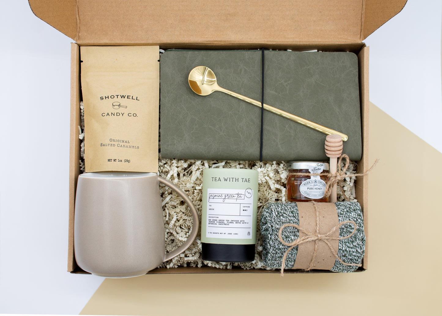 The Dapper Haven (Specially crafted gift box for men. Includes a ceramic mug, golden spoon, tea, honey with dipper, caramel candy, men's socks, and a vegan leather notebook. A gift that brings joy and a touch of tranquility to anyone who loves life's finer things.)