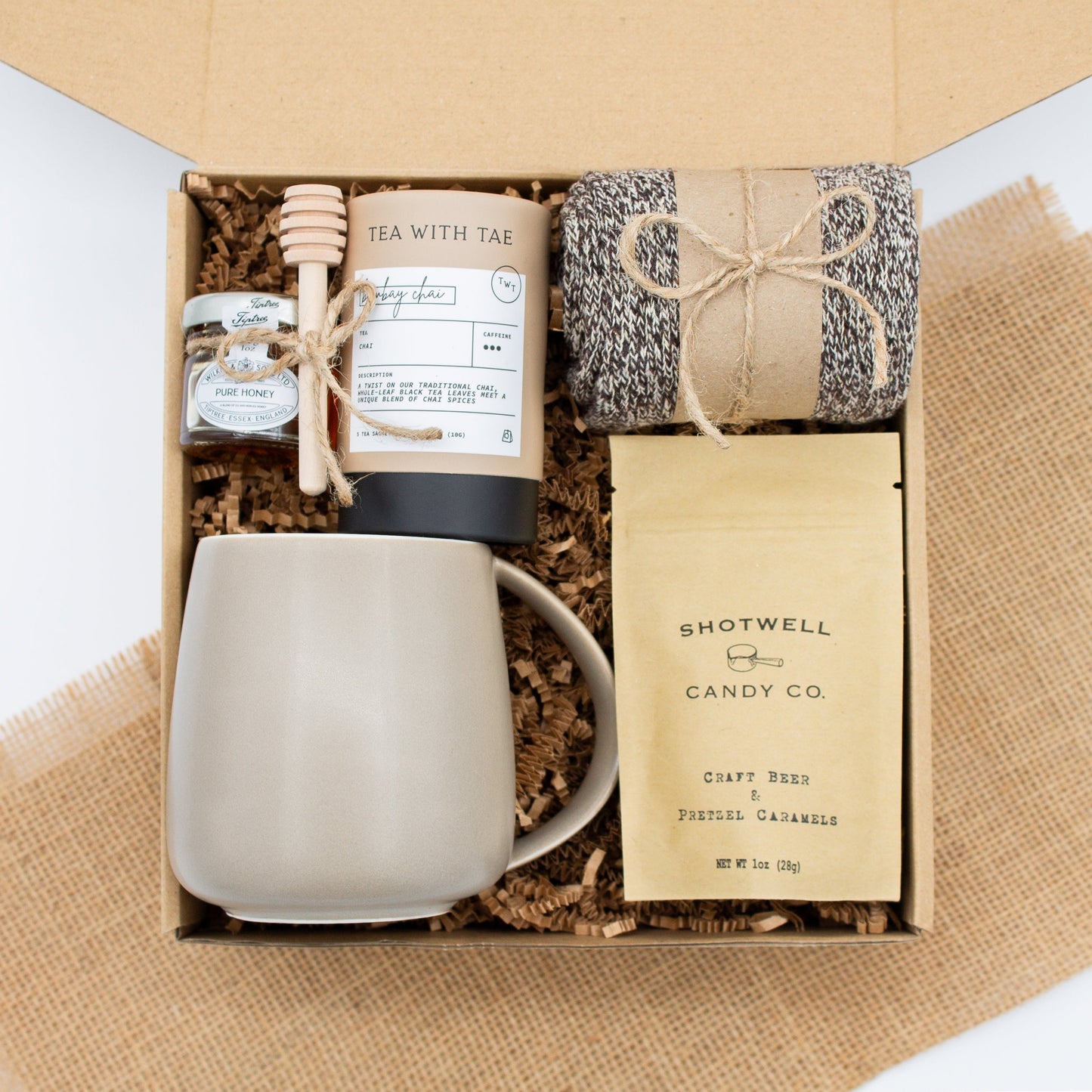 The Dapper Haven Basic (Specially crafted gift box for men. Includes a minimalist ceramic mug, tea, pure honey with wooden dipper, caramel candy, and cozy men's socks. A gift that brings joy and a touch of tranquility to anyone who loves life's finer things.)