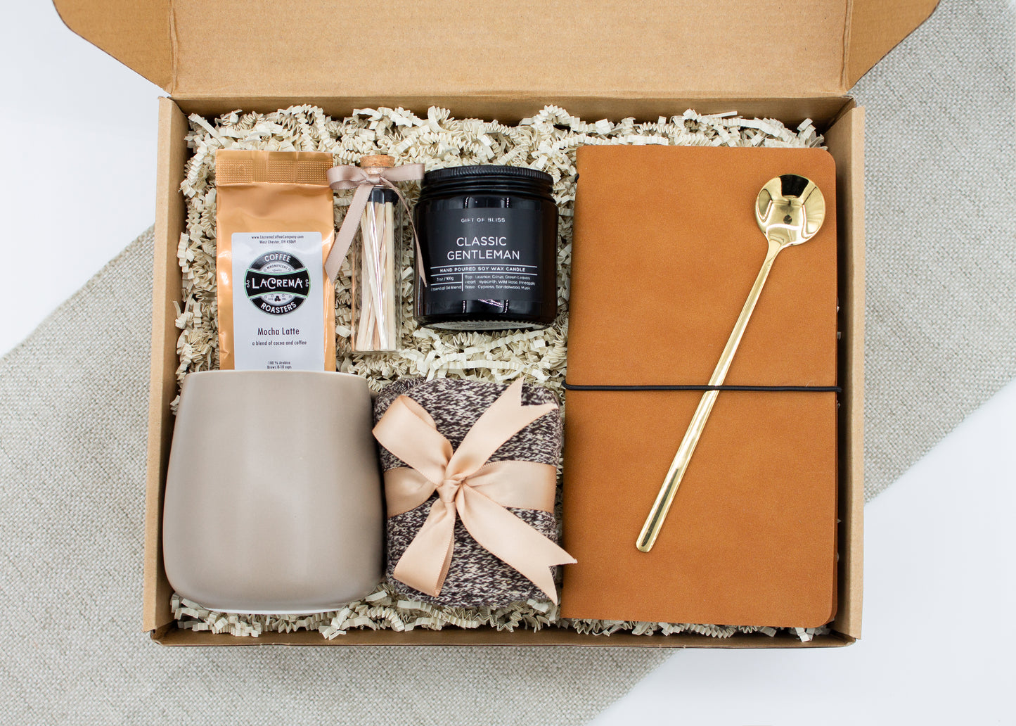Urban Comfort (Specially crafted gift box, ideal for modern individuals who value style and comfort. Includes 12 oz ceramic mug, long-handled golden spoon, rich coffee, aromatic candles and matches, stylish men's socks, and notebook, all arranged for a memorable experience.)