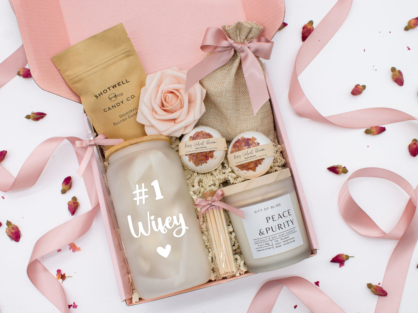Spa gift basket for her with fragrant bath treats, glass cup, soft caramels, relaxing candle, and a beautifull rose. Pick from one of the three scents: Rose, Lavender, or Jasmine. Perfect to pamper and honor her.