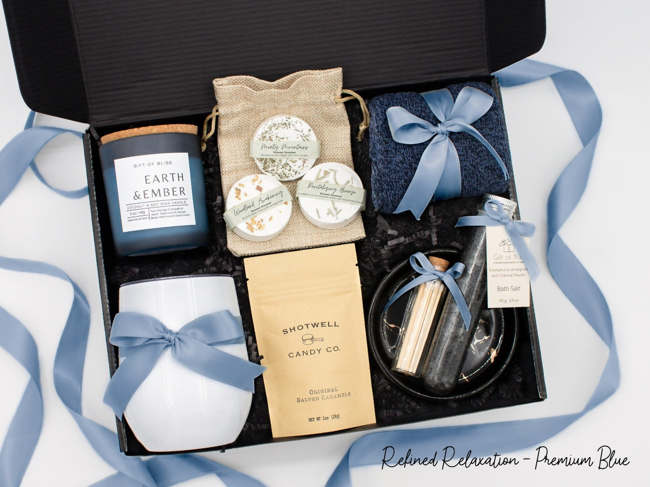 Specially crafted gift box that brings luxury and relaxation. Includes a 12oz stainless steel tumbler, sweet treats, an aromatic candle and matches, cozy socks, bath salt, shower steamers, and an elegant ceramic dish for a serene experience.