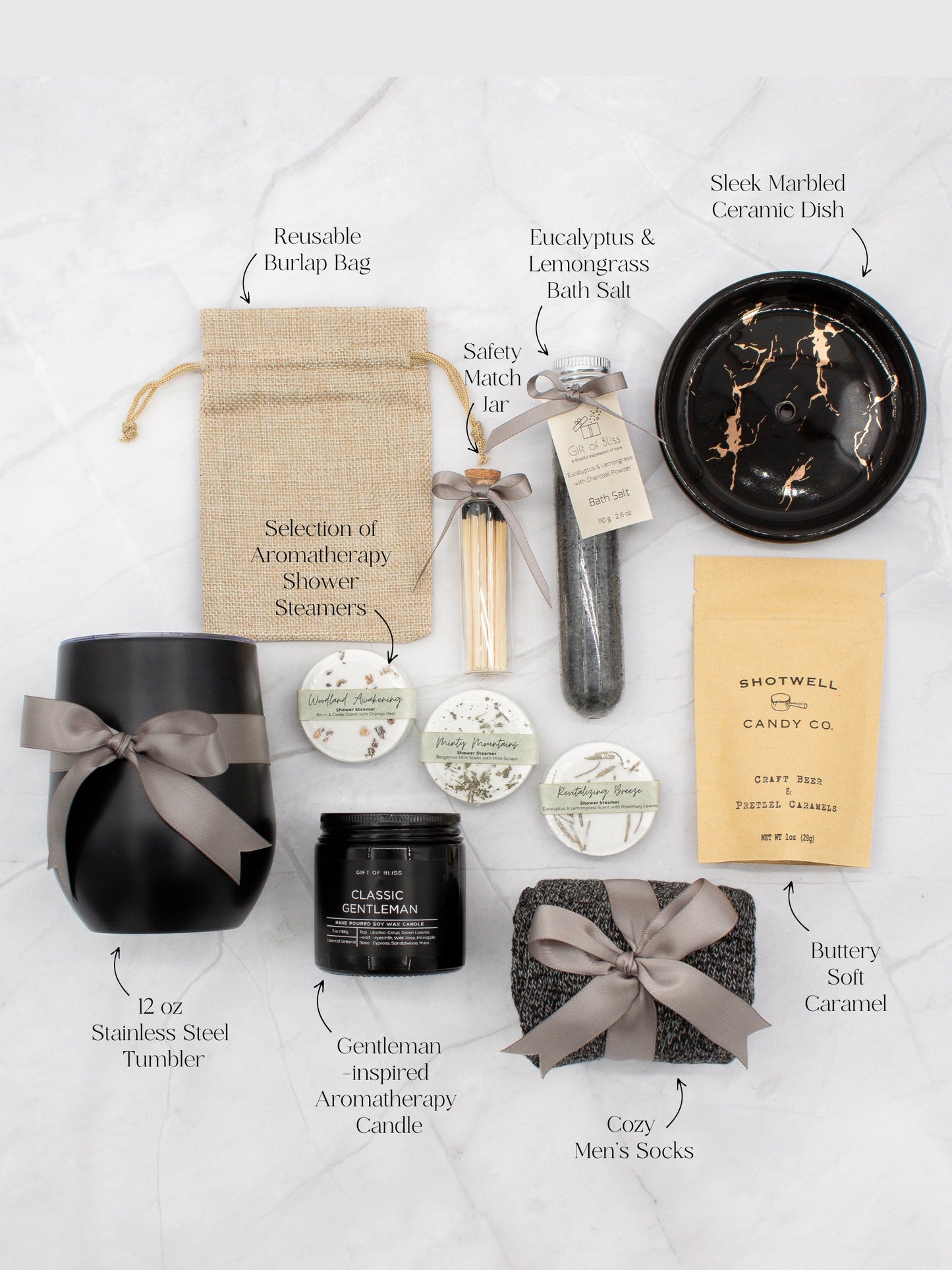 Specially crafted gift box that brings luxury and relaxation. Includes a 12oz stainless steel tumbler, sweet treats, an aromatic candle and matches, cozy socks, bath salt, shower steamers, and an elegant ceramic dish for a serene experience.