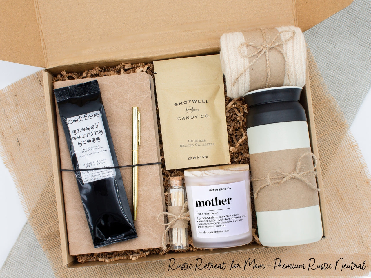 A specially crafted gift box for moms who appreciate rustic charm and elegance. Features 12 oz tumbler, coffee, luxurious caramel, notebook with gold pen, soothing candle with matches, and cozy socks, perfect for both relaxation and practicality.