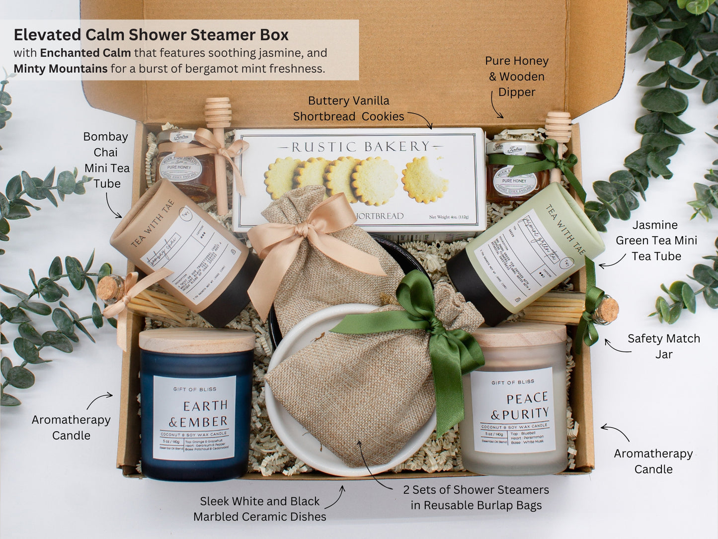 A spa gift box for 2. Features shortbread cookies, 2 soothing tea blends, honey and wooden dipper, 2 aromatic candles, and 2 sets of shower steamers. This elegantly curated box, ideal for couples, enhances shared moments of intimacy and relaxation.