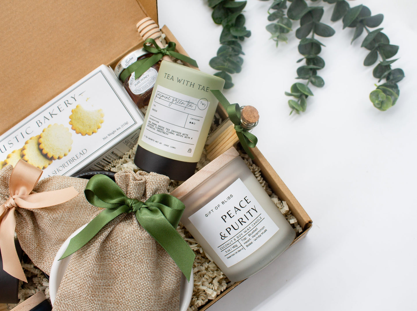 A spa gift box for 2. Features shortbread cookies, 2 soothing tea blends, honey and wooden dipper, 2 aromatic candles, and 2 sets of shower steamers. This elegantly curated box, ideal for couples, enhances shared moments of intimacy and relaxation.