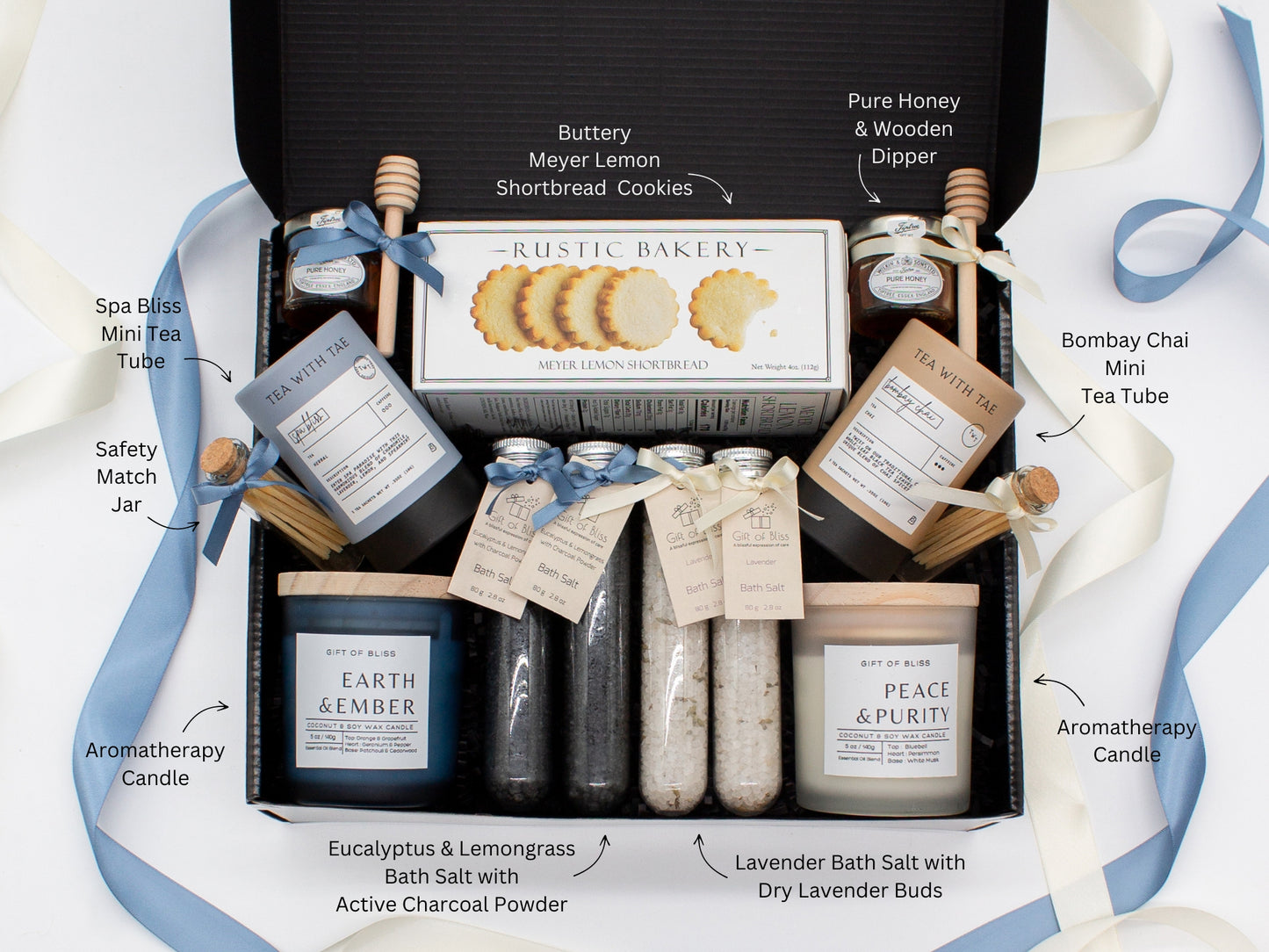A spa gift box for two. Features shortbread cookies, 2 soothing tea blends, pure honey and wooden dipper, 2 aromatic candles, and 2 sets of bath salt. This elegantly curated box, ideal for couples, enhances shared moments of intimacy and relaxation.