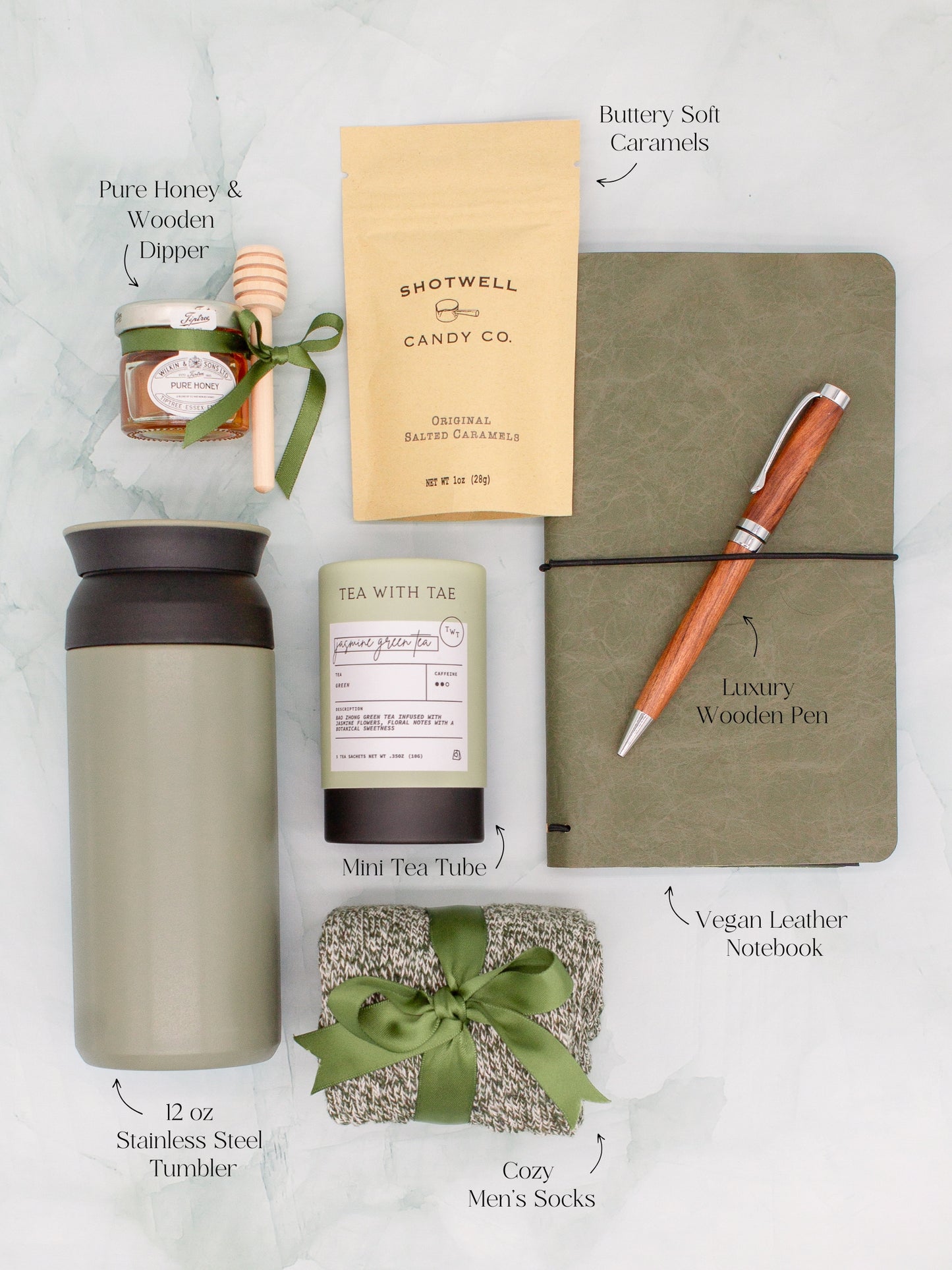 Specially crafted gift box for men, ideal for anyone. Includes a stainless steel tumbler, tea, honey, sweet treats, cozy socks, vegan leather notebook, & wooden pen. Perfect for relaxation & appreciation, complete with a personalized greeting card.