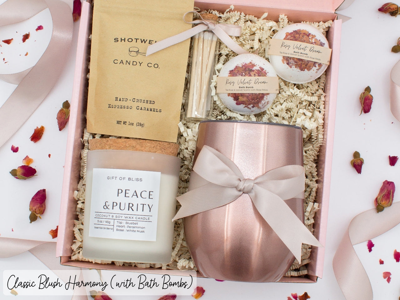 Luxury gift box for her. Featuring a stainless steel tumbler, an aromatherapy candle with matches, luxury bath bombs, and gourmet caramel treats. All items are beautifully arranged for a pampering experience.