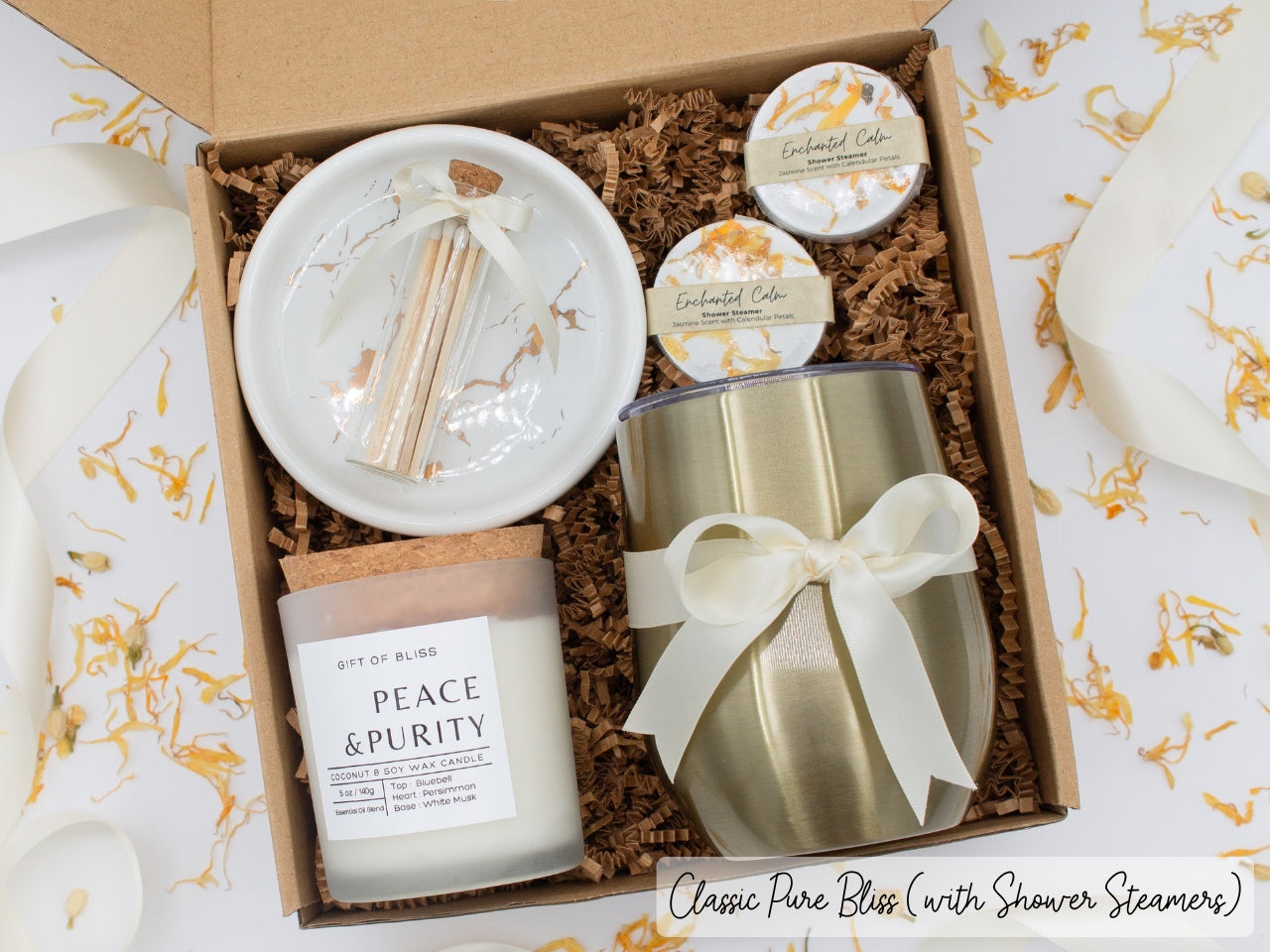 Luxury gift box for her. Featuring a stainless steel tumbler, an aromatherapy candle with matches, aromatic shower steamers, and a sleek ceramic dish. All items are beautifully arranged for a pampering experience.