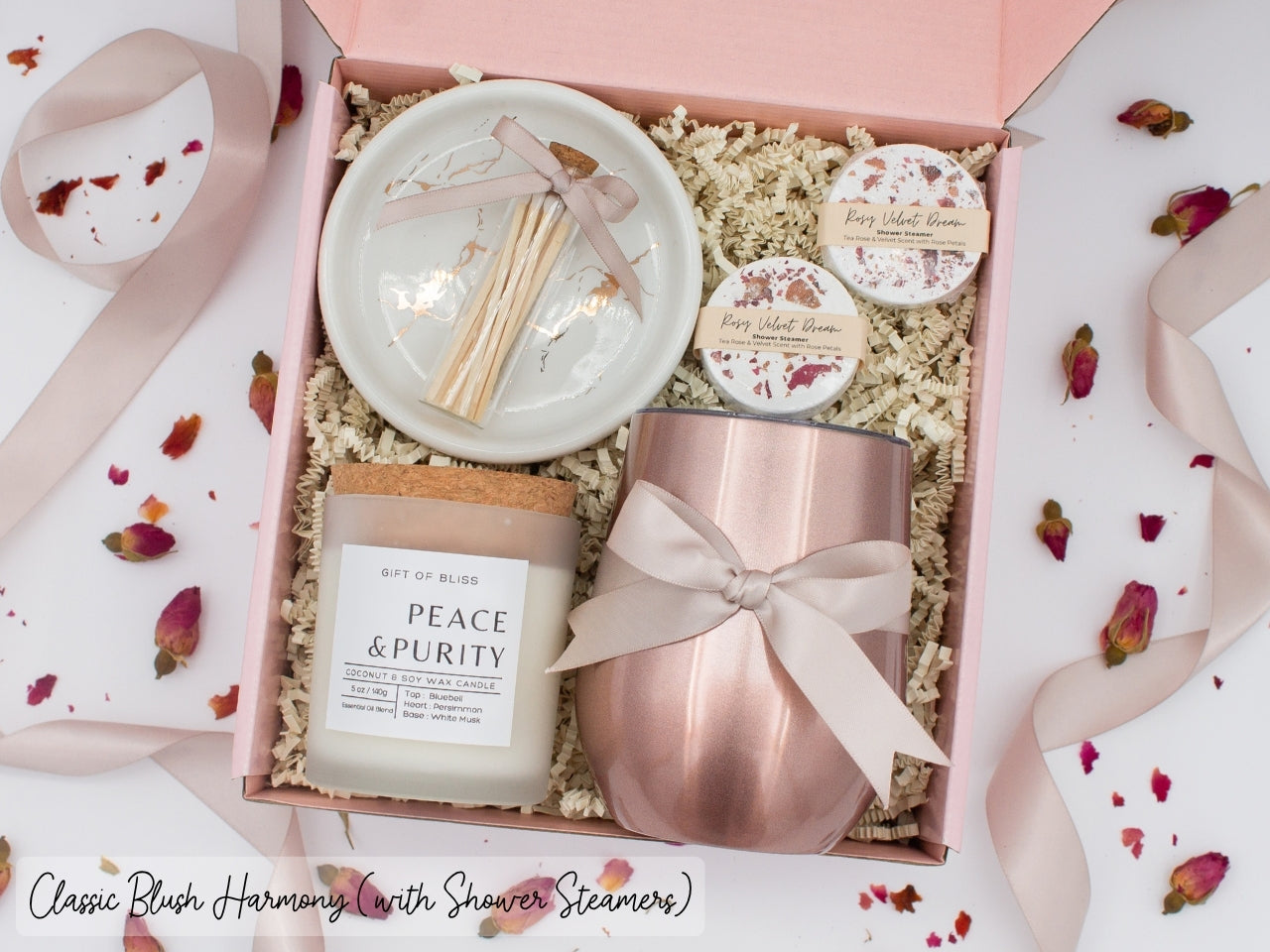 Luxury gift box for her. Featuring a stainless steel tumbler, an aromatherapy candle with matches, aromatic shower steamers, and a sleek ceramic dish. All items are beautifully arranged for a pampering experience.