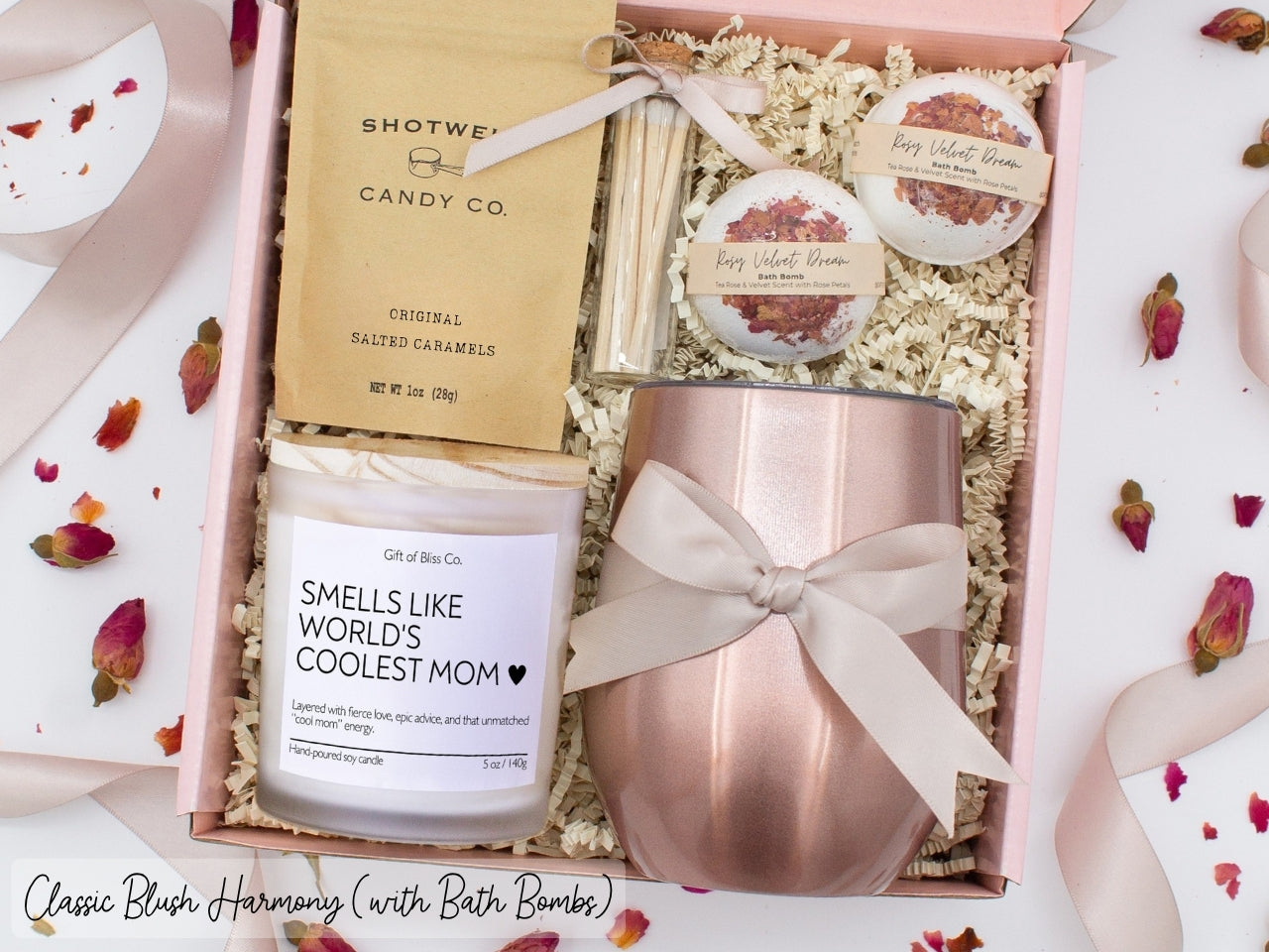 Luxury gift box for mom. Featuring a stainless steel tumbler, an aromatherapy candle with with mom-themed label and charming match jar, luxury bath bombs, and gourmet caramel treats. All items are beautifully arranged for a pampering experience.