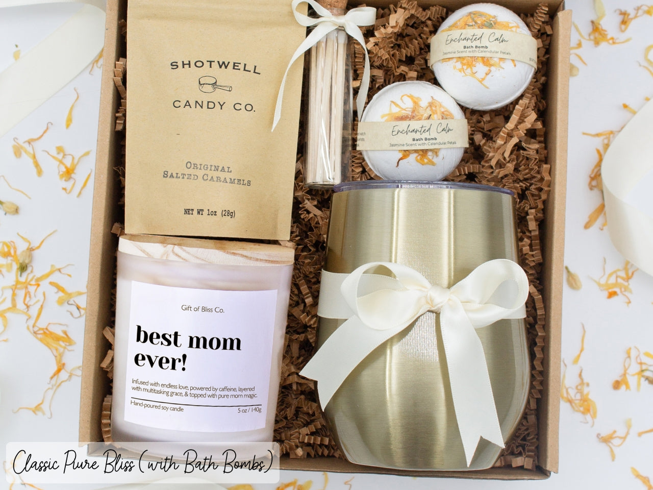 Luxury gift box for mom. Featuring a stainless steel tumbler, an aromatherapy candle with mom-themed label and charming match jar, luxury bath bombs, and gourmet caramel treats. All items are beautifully arranged for a pampering experience.