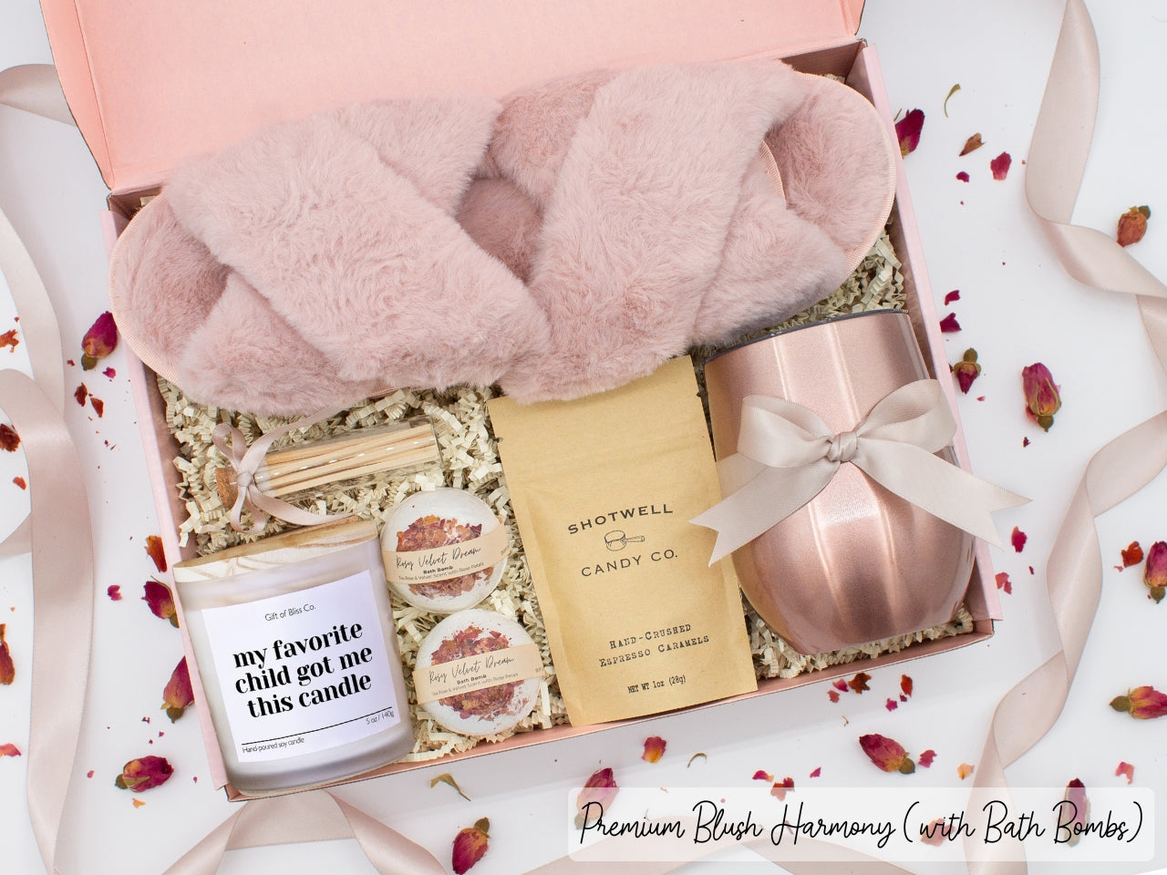 Luxury gift box for mom. Featuring a stainless steel tumbler, an aromatherapy candle with mom-themed label and charming match jar, luxury bath bombs, plush open-toe slippers, and gourmet caramel treats. All items are beautifully arranged for a pampering experience.