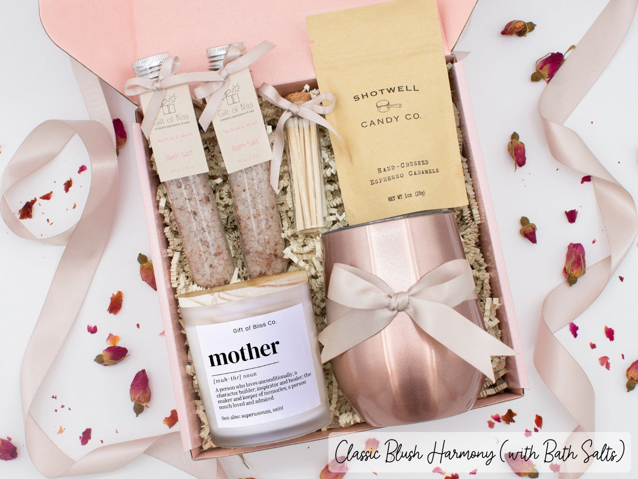 Luxury gift box for her. Featuring a stainless steel tumbler, an aromatherapy candle with mom-themed label and a charming match jar, therapeutic bath salts, and gourmet caramel treats. All items are beautifully arranged for a pampering experience.