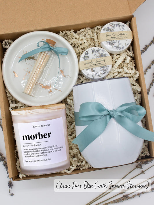 Luxury gift box for her. Featuring a stainless steel tumbler, an aromatherapy candle with mom-themed label and charming match jar, aromatic shower steamers, and a sleek ceramic dish. All items are beautifully arranged for a pampering experience.
