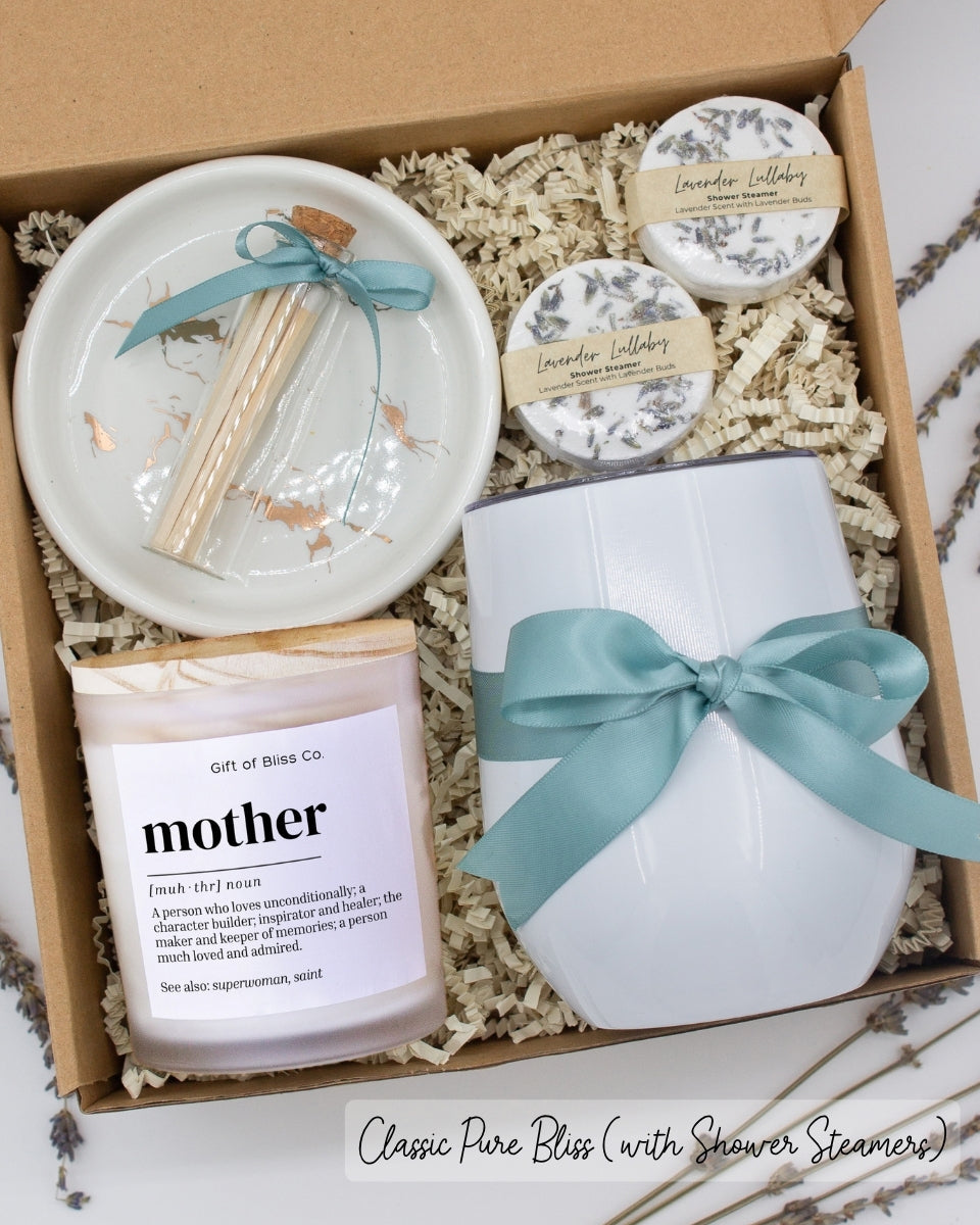 Luxury gift box for mom. Featuring a stainless steel tumbler, an aromatherapy candle with mom-themed label and charming match jar, aromatic shower steamers, and a sleek ceramic dish. All items are beautifully arranged for a pampering experience.