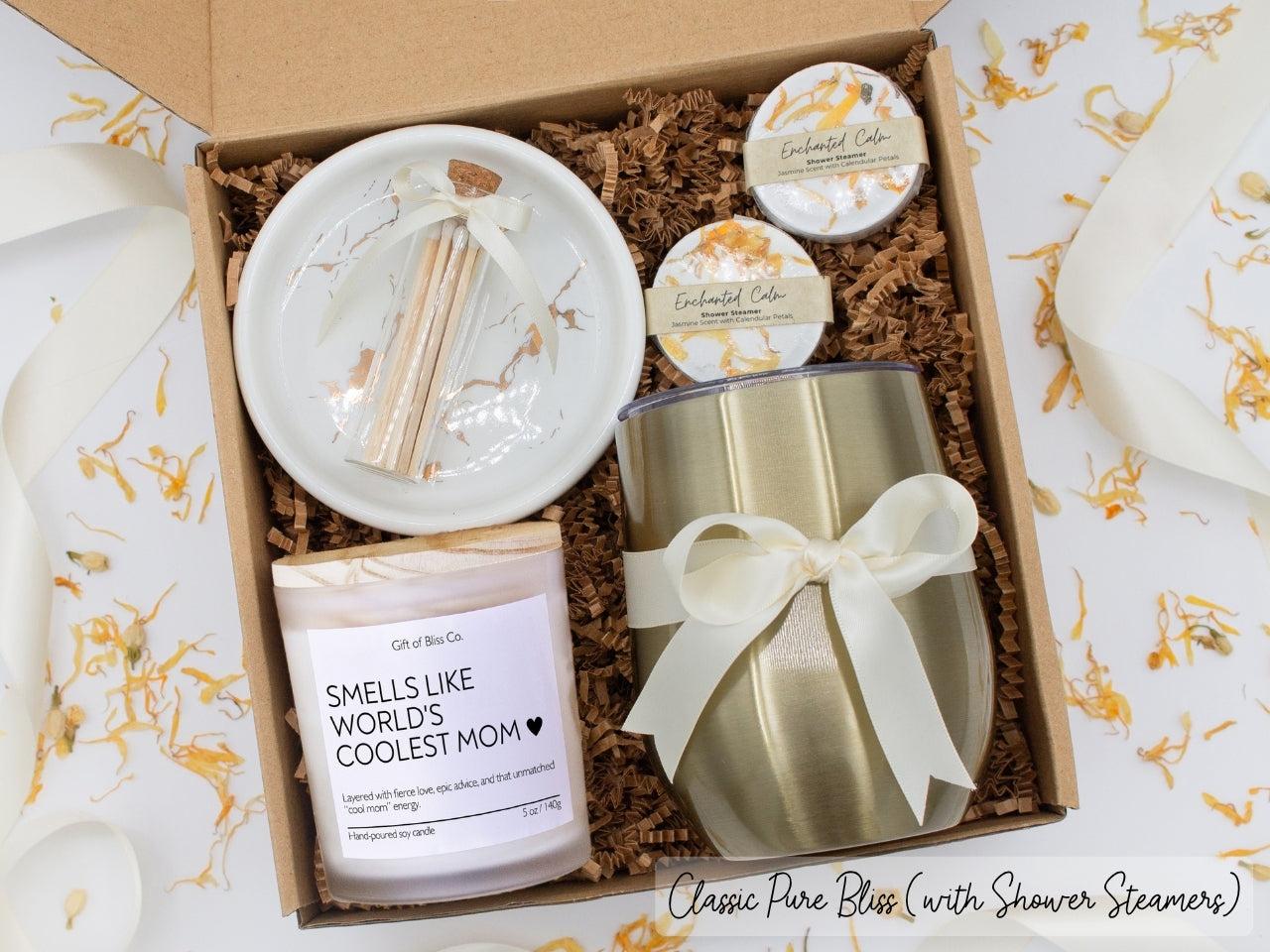 Luxury gift box for mom. Featuring a stainless steel tumbler, an aromatherapy candle with mom-themed label and charming match jar, aromatic shower steamers, and a sleek ceramic dish. All items are beautifully arranged for a pampering experience.