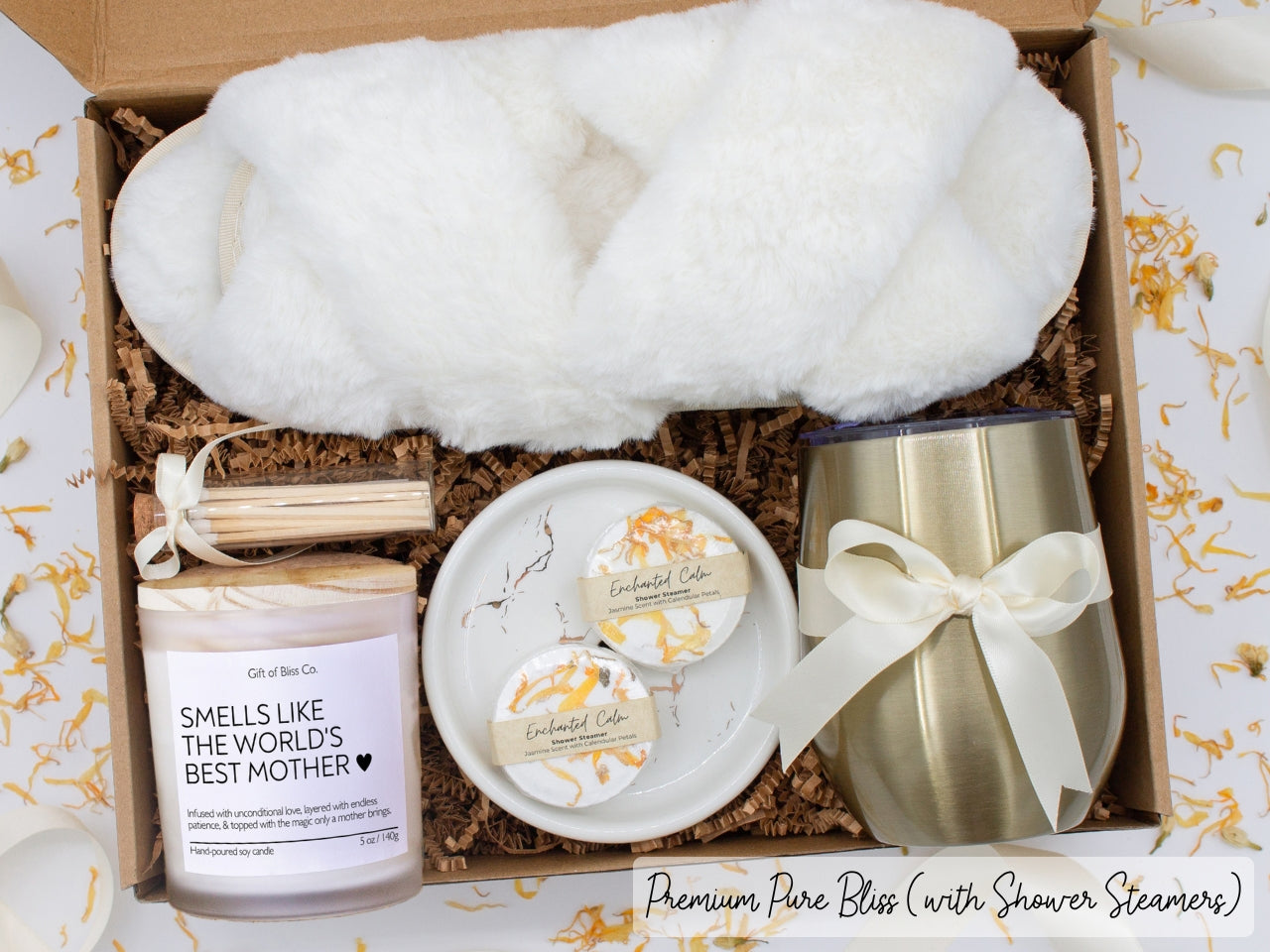 Luxury gift box for her. Featuring a stainless steel tumbler, an aromatherapy candle with mom-themed label and charming match jar, aromatic shower steamers, sleek ceramic dish, and plush open-toe slippers. All items are beautifully arranged for a pampering experience.