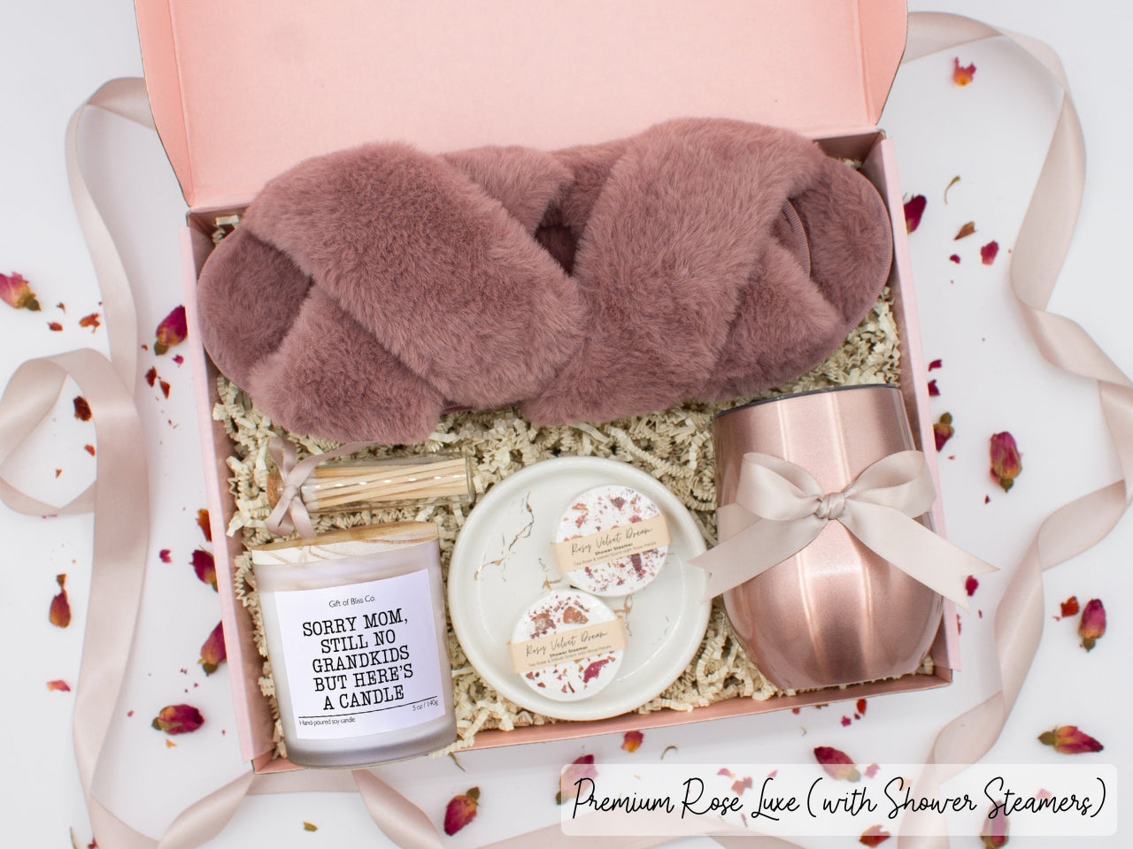 Luxury gift box for her. Featuring a stainless steel tumbler, an aromatherapy candle with mom-themed label and charming match jar, aromatic shower steamers, sleek ceramic dish, and plush open-toe slippers. All items are beautifully arranged for a pampering experience.