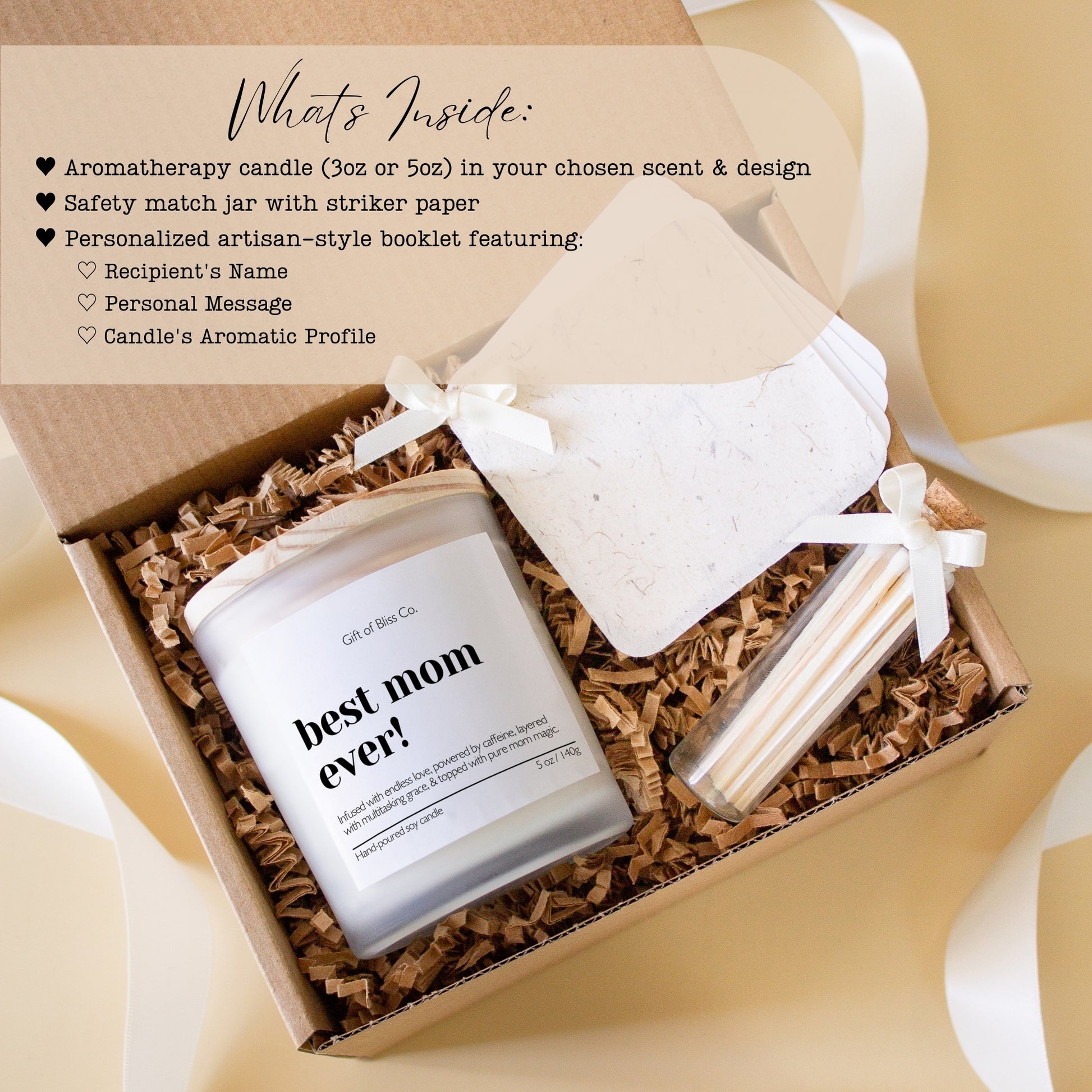 Candle gift box featuring a “best mom ever” soy candle, glass match jar, and a personalized message booklet tied with ivory ribbon. Arranged in a kraft box with crinkle paper filler and neutral tones, this cozy, elegant, handcrafted gift is perfect for Mother’s Day or mom appreciation. A heartfelt and aesthetic set that combines warmth, functionality, and luxury charm.