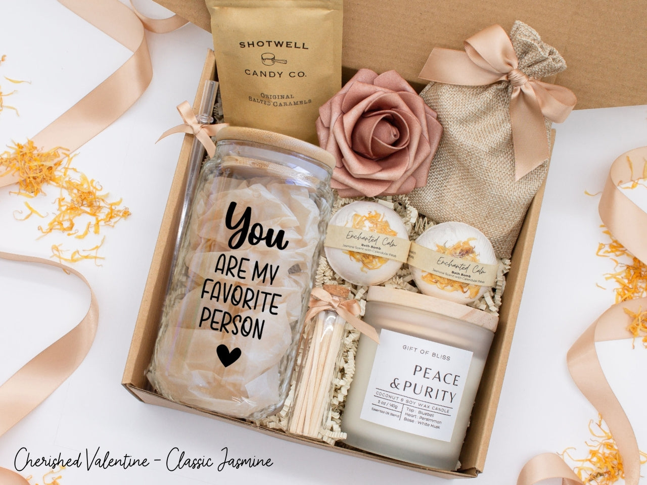 Pesonalized Valentine's Day spa gift basket for her with fragrant bath treats, personalized glass tumbler, soft caramels, relaxing candle, and a beautifull rose. Pick from one of the three scents: Rose, Lavender, or Jasmine. Perfect to pamper and honor her.