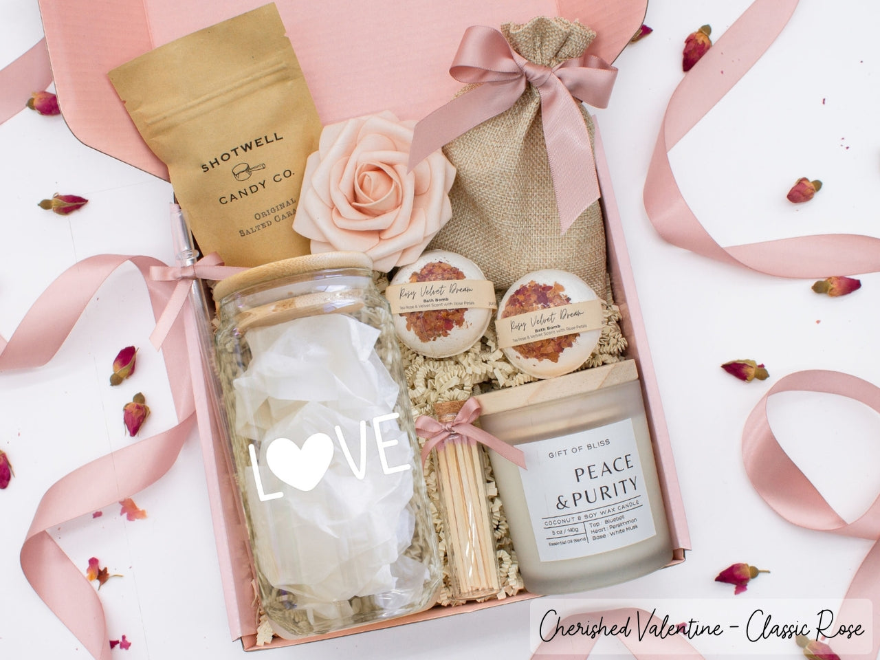 Pesonalized Valentine's Day spa gift basket for her with fragrant bath treats, personalized glass tumbler, soft caramels, relaxing candle, and a beautifull rose. Pick from one of the three scents: Rose, Lavender, or Jasmine. Perfect to pamper and honor her.