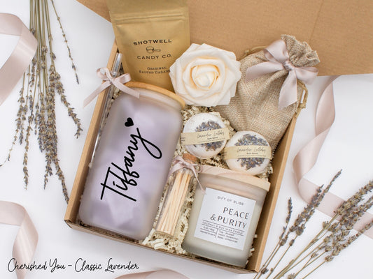 Pesonalized spa gift basket for her with fragrant bath treats, personalized glass tumbler, soft caramels, relaxing candle, and a beautifull rose. Pick from one of the three scents: Rose, Lavender, or Jasmine. Perfect to pamper and honor her.