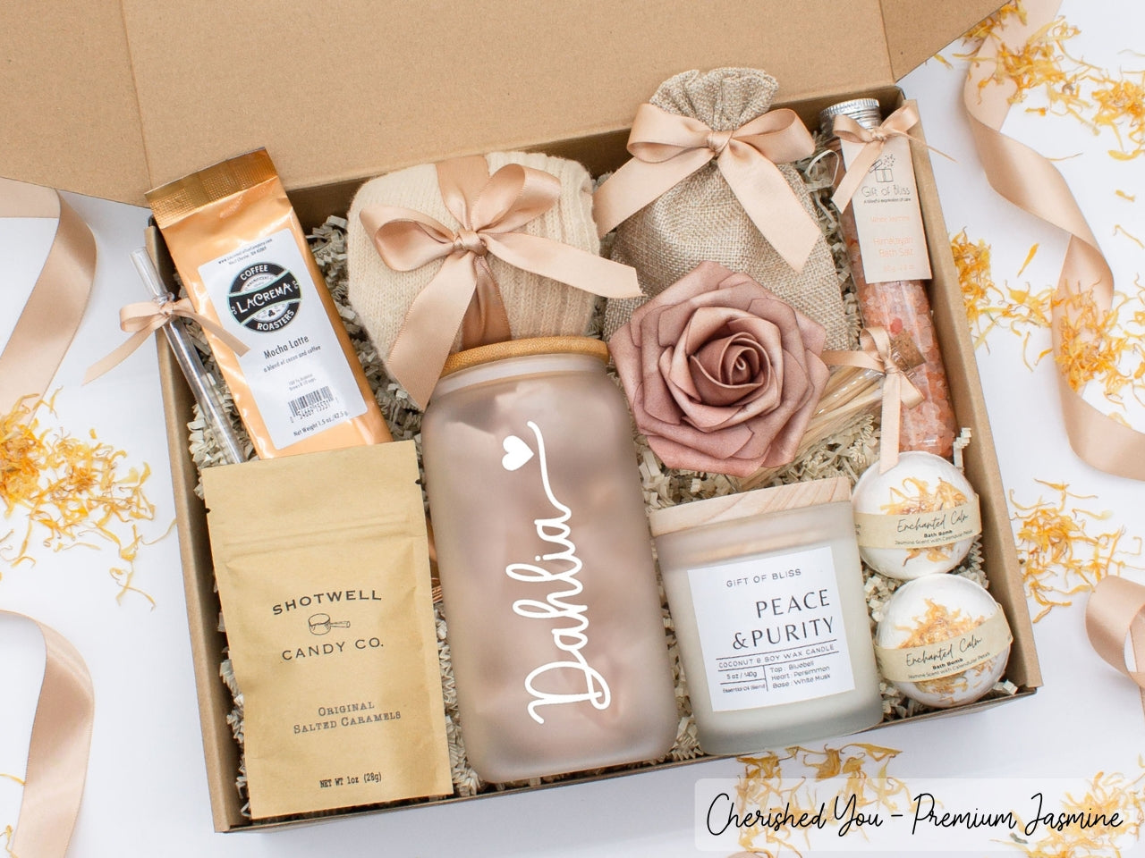Personalized spa gift set for her with bath treats, personalized glass tumbler, mocha latte coffe, caramels, relaxing candle, cozy socks, and a lovely rose. Pick from 1 of the three scents: Rose, Lavender, or Jasmine. Perfect to pamper and honor her.