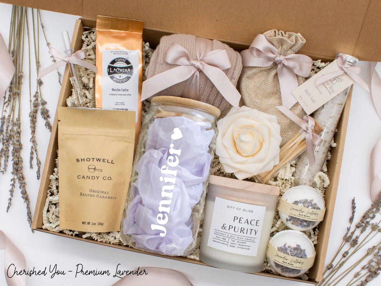 Personalized spa gift set for her with bath treats, personalized glass tumbler, mocha latte coffe, caramels, relaxing candle, cozy socks, and a lovely rose. Pick from 1 of the three scents: Rose, Lavender, or Jasmine. Perfect to pamper and honor her.