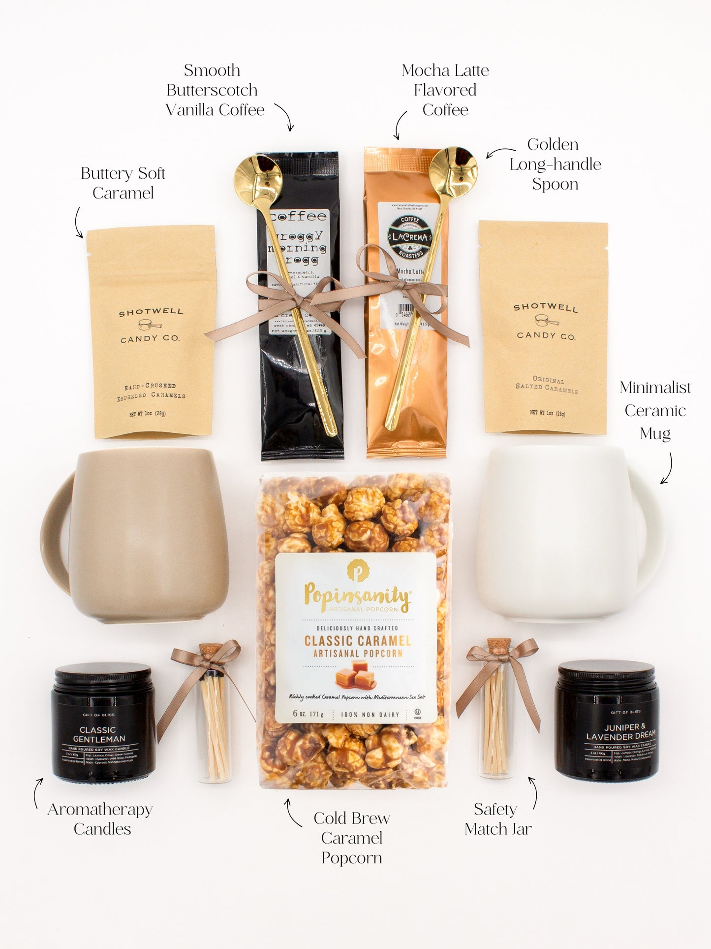 A gift box for two. Includes two ceramic mugs with golden spoons, a selection of fine coffees, two safety match jars, his and hers aromatherapy candles, caramel candies, and artisan popcorn, all for shared moments of joy.
