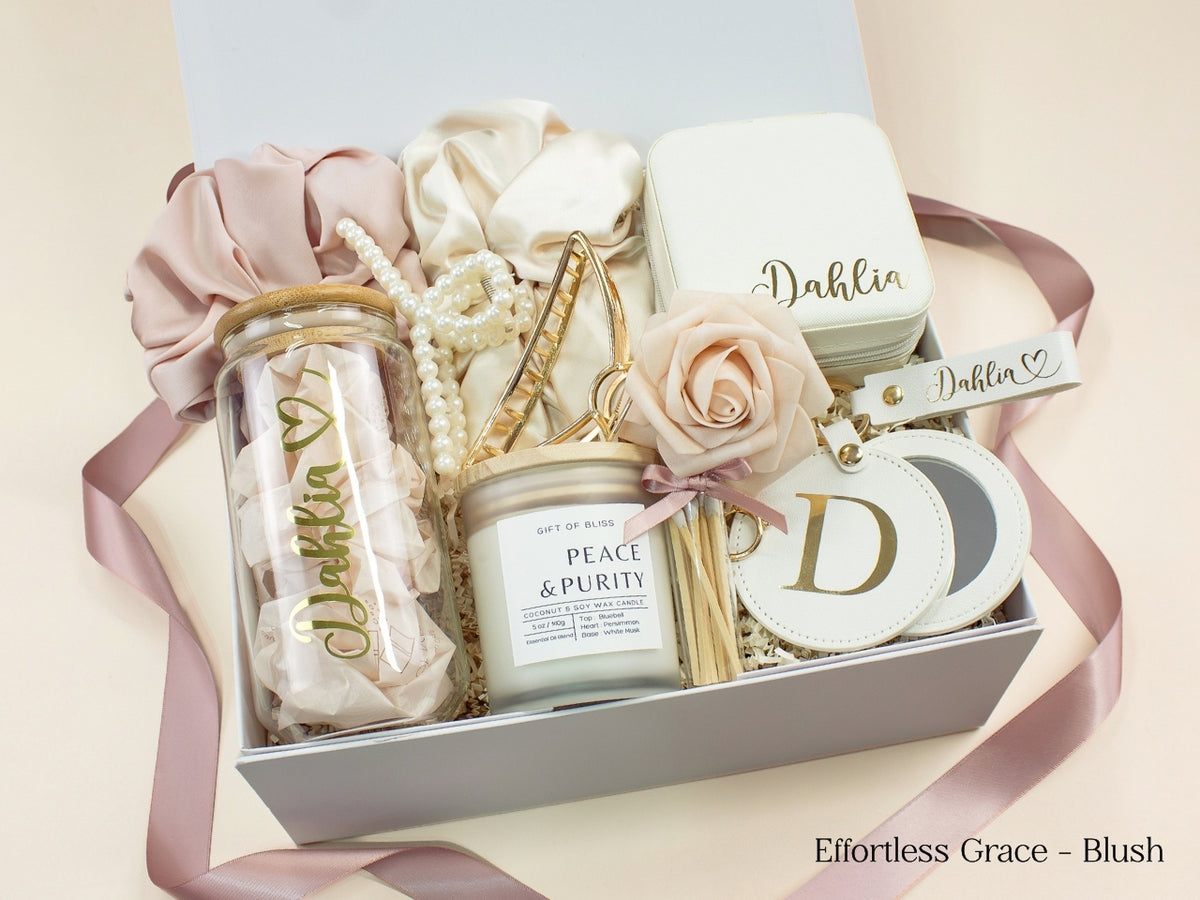 Blush personalized gift box for her with glass tumbler, jewelry case, candle, satin scrunchies, pearl hair accessories, gold claw clip, mirror and custom name details.