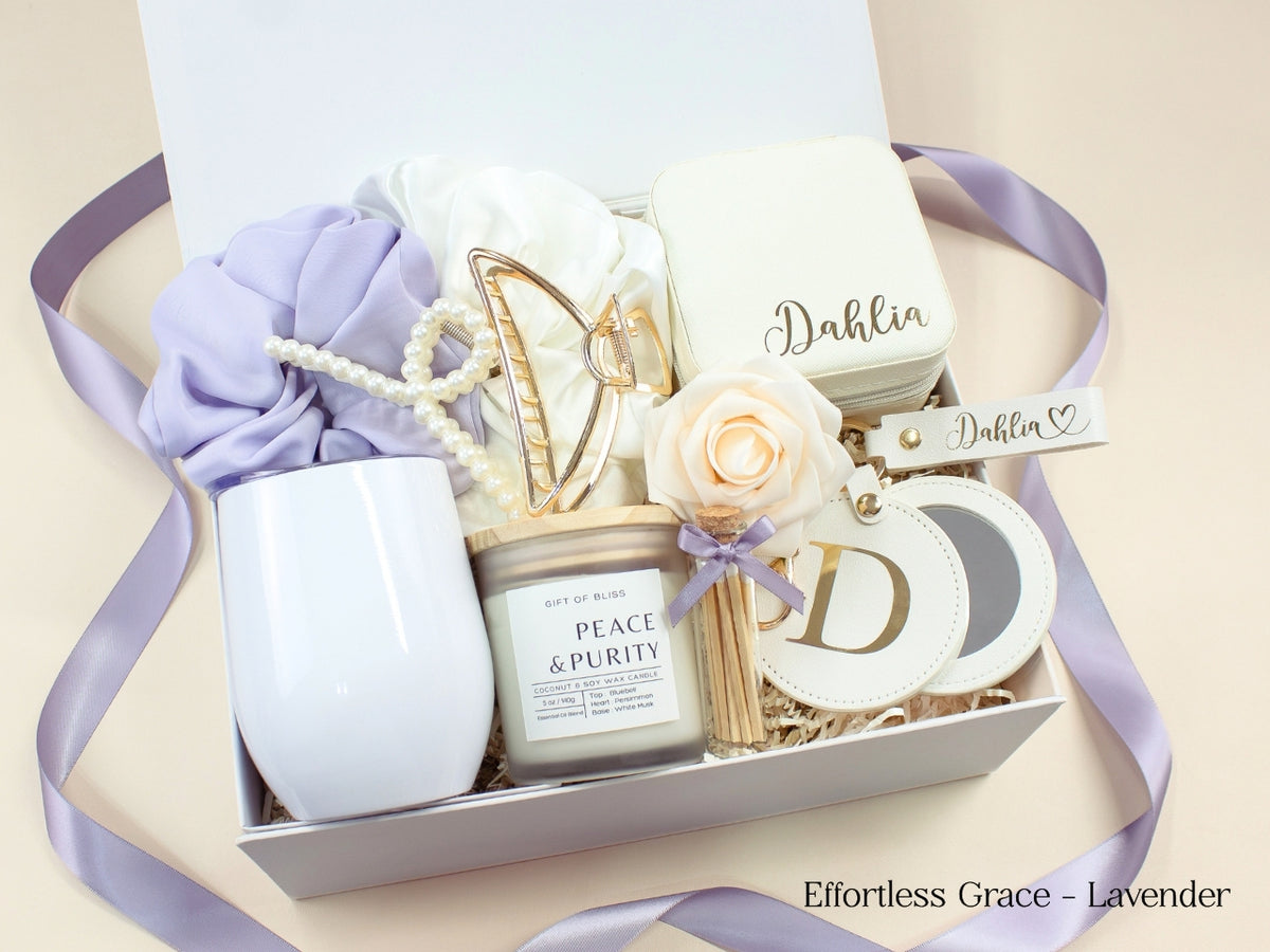 Lavender personalized gift box for women with white wine tumbler, travel jewelry case, candle, satin scrunchies, pearl hair accessories, gold claw clip and initial mirror.