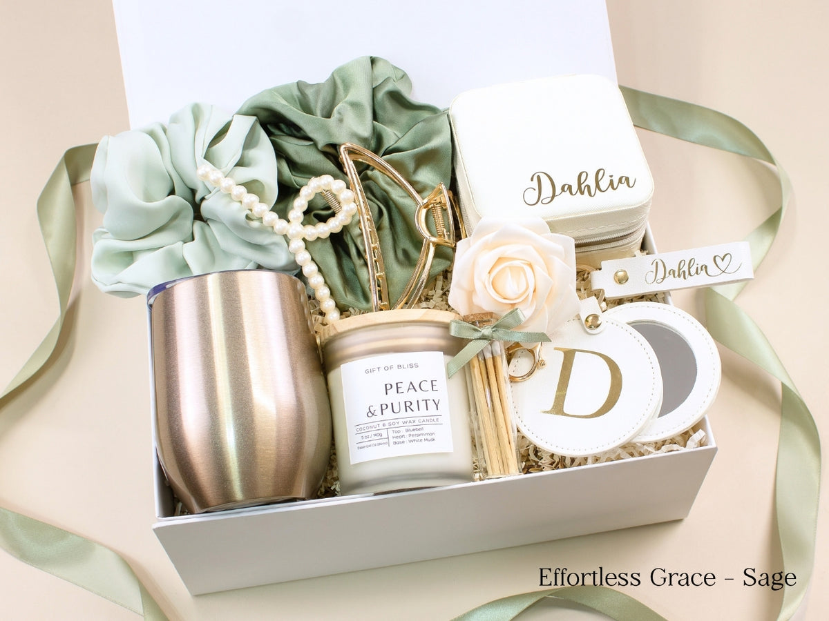 Sage green personalized gift box for her with wine tumbler, jewelry case, candle, satin scrunchies, pearl hair accessories, gold claw clip and monogram mirror.