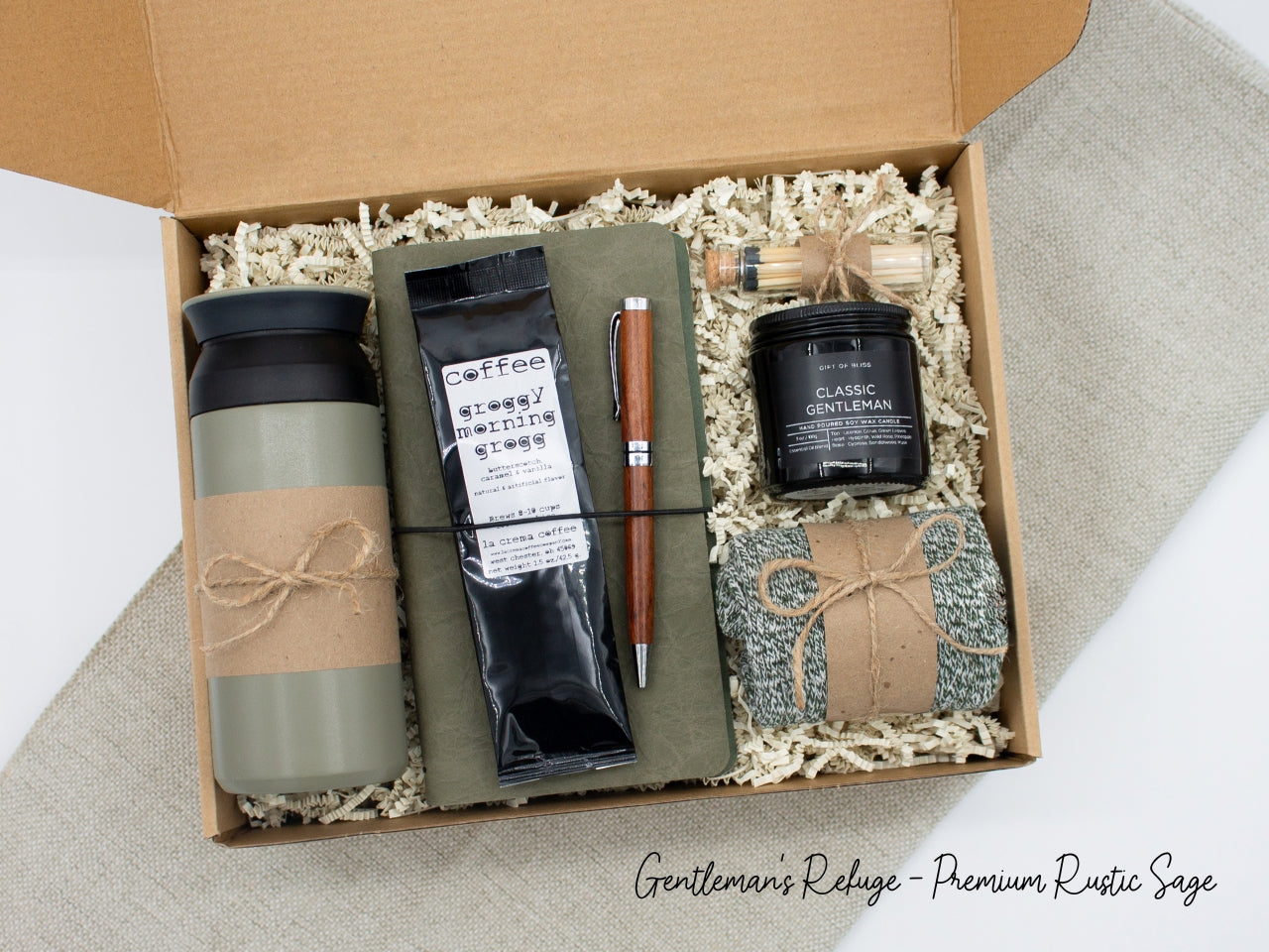 Specially crafted gift box for men, suitable for anyone valuing timeless style. Includes a stainless steel tumbler, coffee, aromatherapy candle, men's socks, notebook, and a wooden pen. A perfect gift for a comforting & indulgent experience.