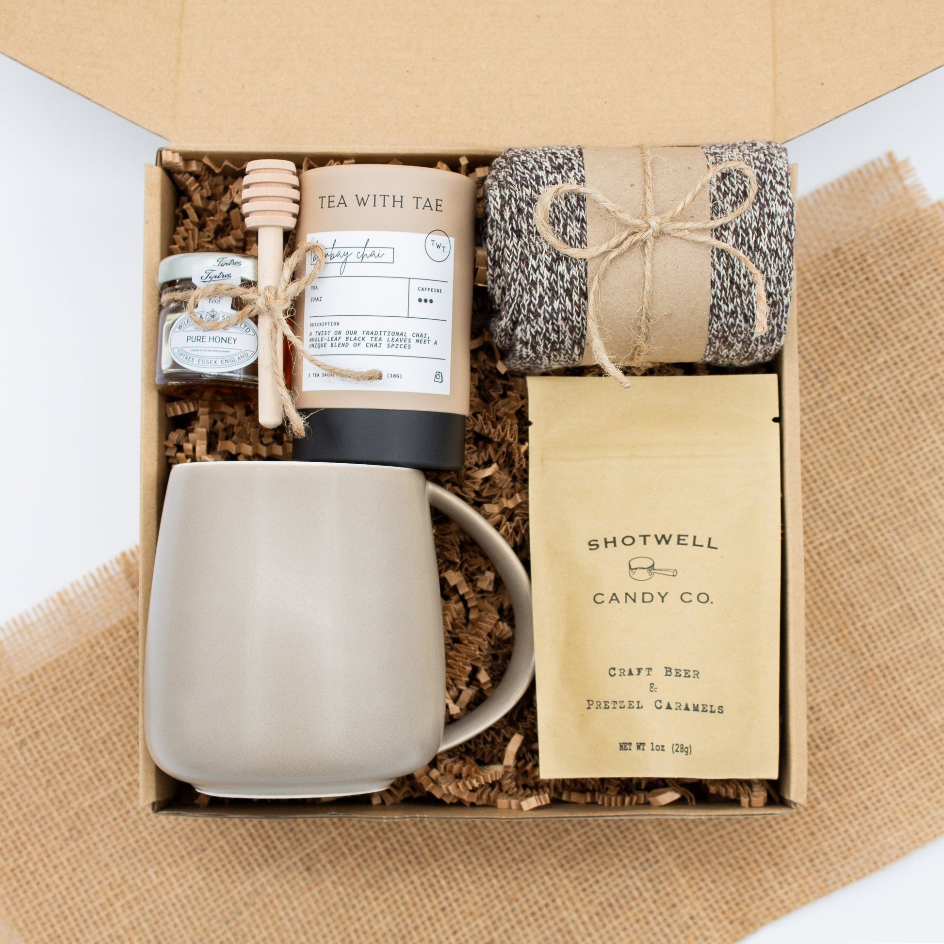 The Dapper Haven Basic (Specially crafted gift box for men. Includes a minimalist ceramic mug, tea, pure honey with wooden dipper, caramel candy, and cozy men's socks. A gift that brings joy and a touch of tranquility to anyone who loves life's finer things.)