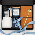 Urban Comfort (Specially crafted gift box, ideal for modern individuals who value style and comfort. Includes 12 oz ceramic mug, long-handled golden spoon, rich coffee, aromatic candles and matches, stylish men's socks, and notebook, all arranged for a memorable experience.)