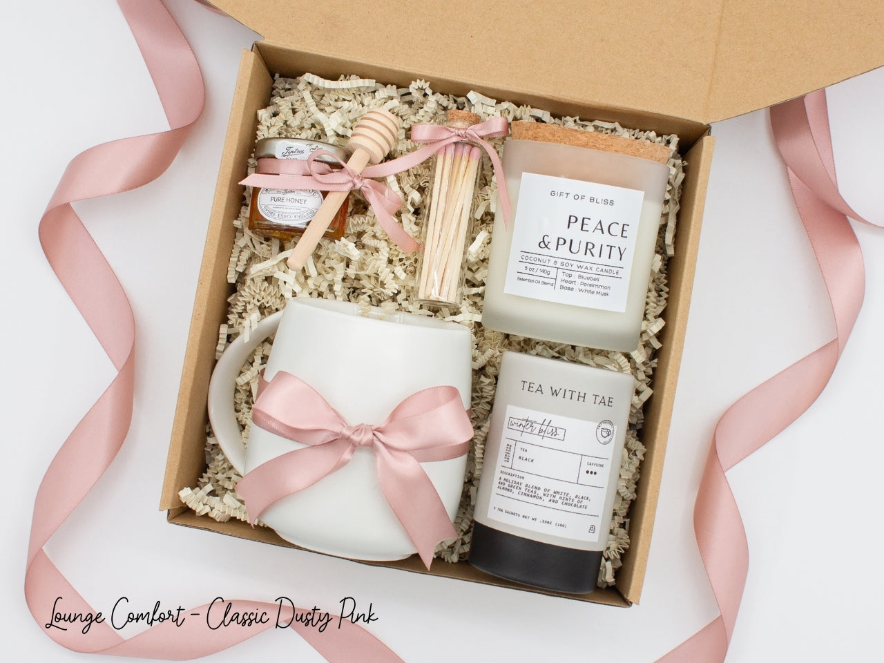 An elegance gift box for women, but perfect for anyone seeking sophistication. Includes a ceramic mug, aromatherapy candle and safety match jar, pure honey with dipper, and a mini tea tube. All beautifully arranged for a serene experience.