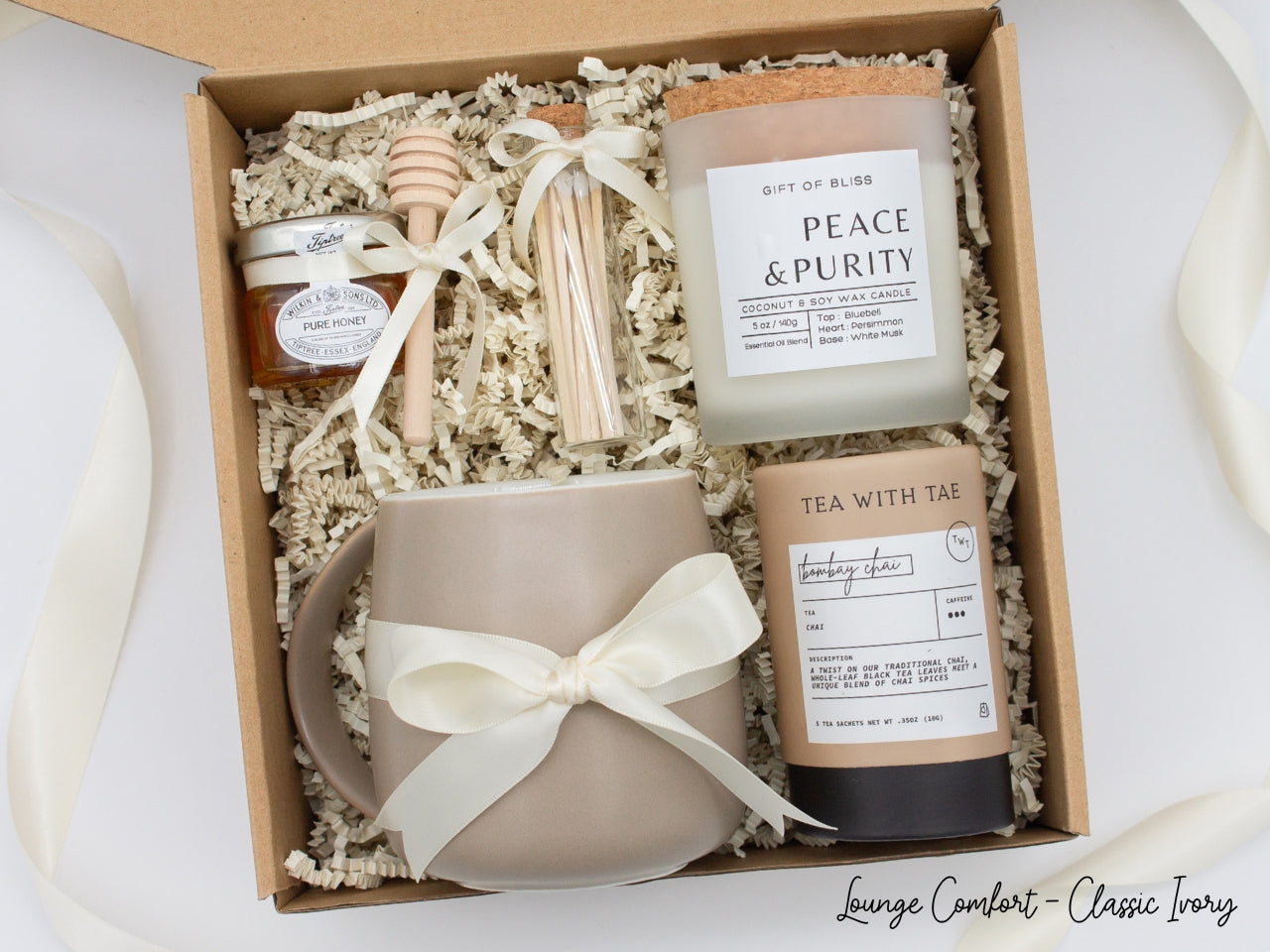 An elegance gift box for women, but perfect for anyone seeking sophistication. Includes a ceramic mug, aromatherapy candle and safety match jar, pure honey with dipper, and a mini tea tube. All beautifully arranged for a serene experience.