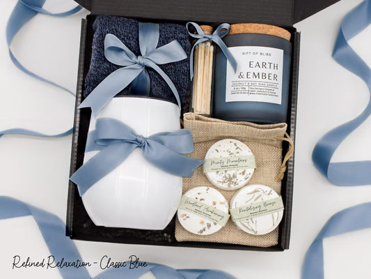 Specially crafted gift box that brings luxury and relaxation. Includes a 12oz stainless steel tumbler, sweet treats, an aromatic candle and matches, cozy socks, and a selection of shower steamer for a serene experience.