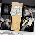 Specially crafted gift box that brings luxury and relaxation. Includes a 12oz stainless steel tumbler, sweet treats, an aromatic candle and matches, cozy socks, bath salt, shower steamers, and an elegant ceramic dish for a serene experience.