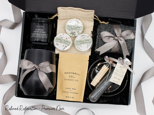 Specially crafted gift box that brings luxury and relaxation. Includes a 12oz stainless steel tumbler, sweet treats, an aromatic candle and matches, cozy socks, bath salt, shower steamers, and an elegant ceramic dish for a serene experience.
